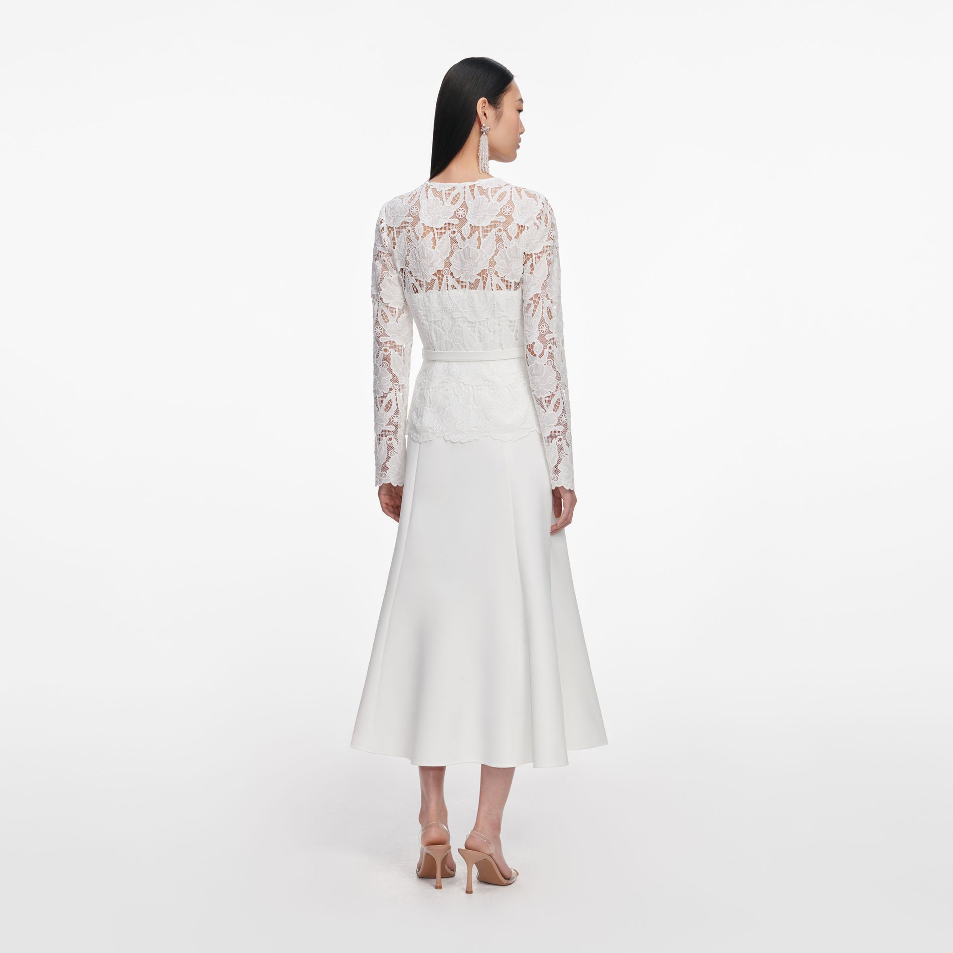 Back view of a woman wearing the White Lace Crepe Midi Dress