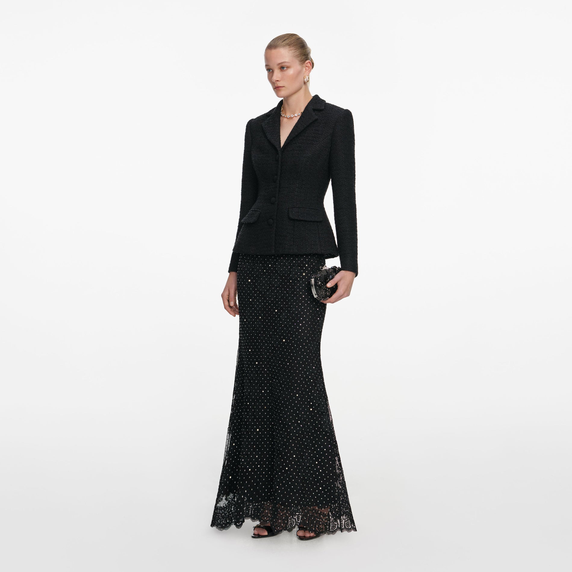 Side view of a woman wearing the Black Boucle Rhinestone Lace Maxi Dress