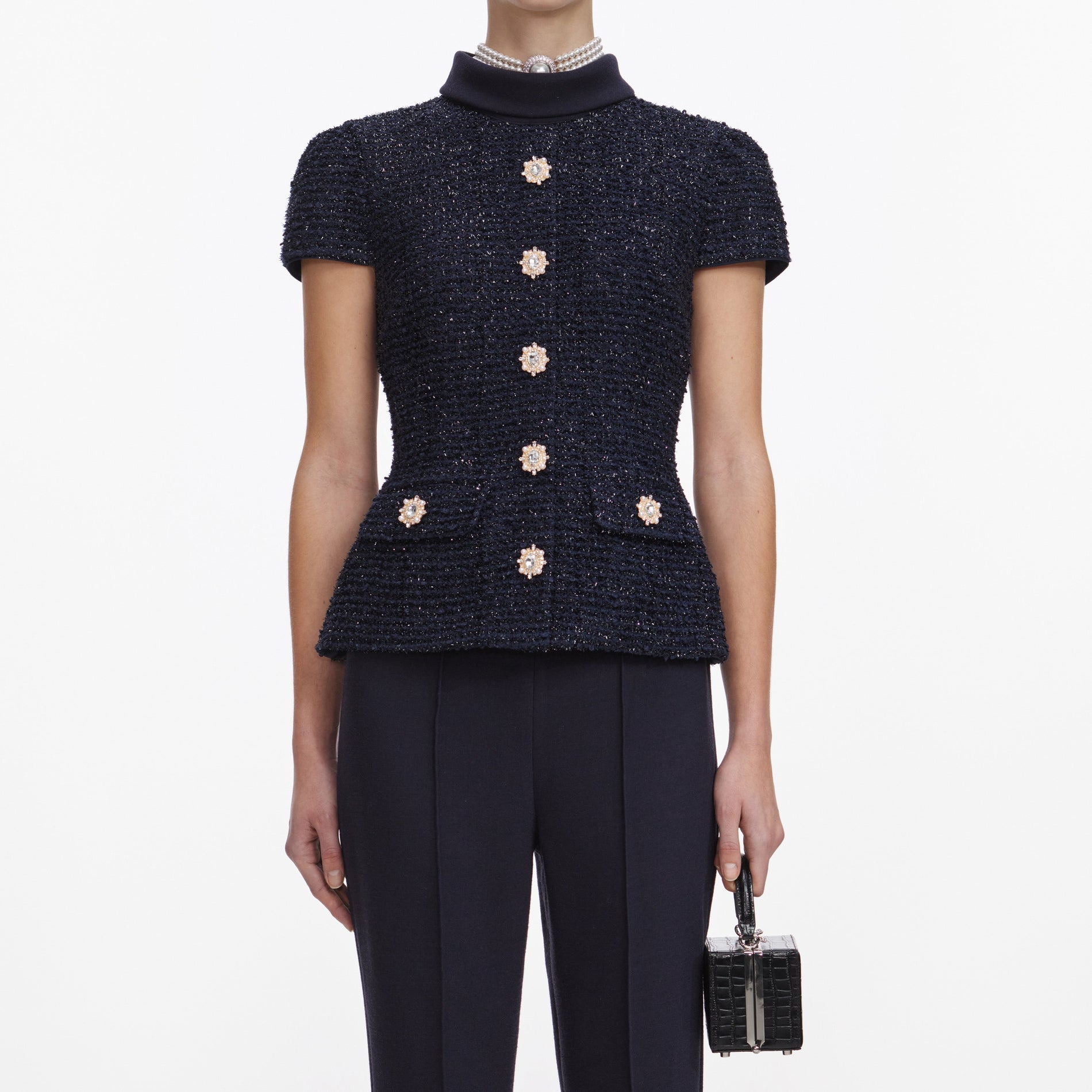 A close up of a woman wearing the Navy Metallic Boucle Jumpsuit