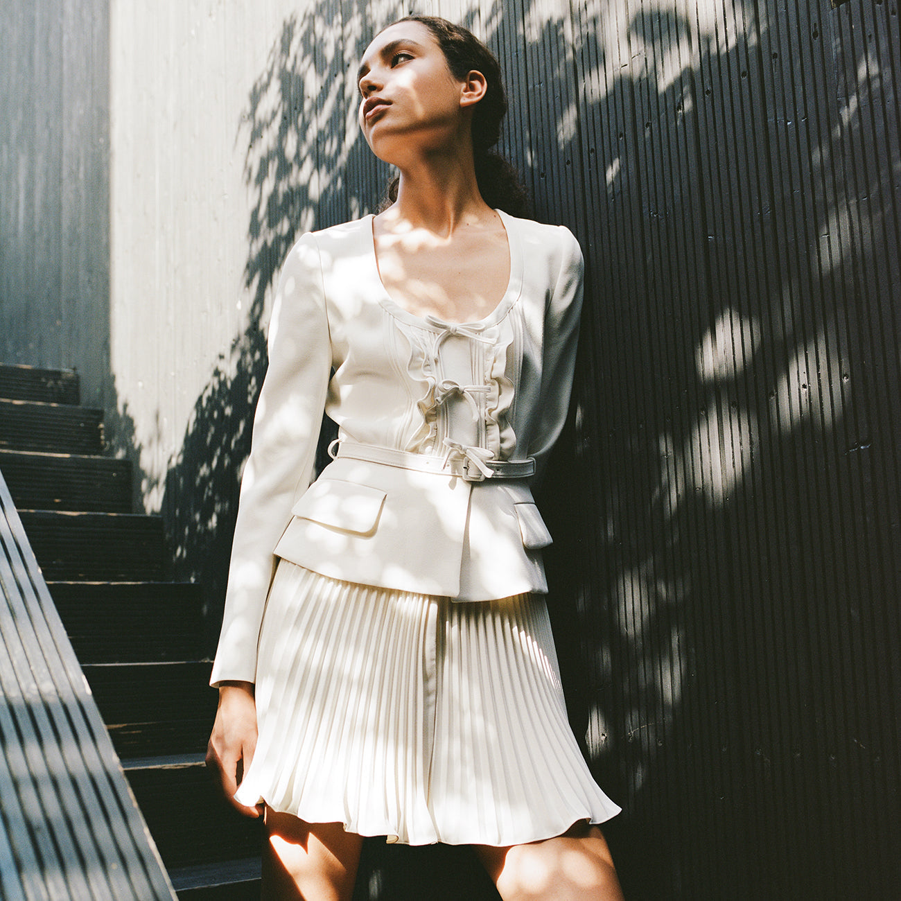 A woman wearing the Ivory Crepe Mini Dress