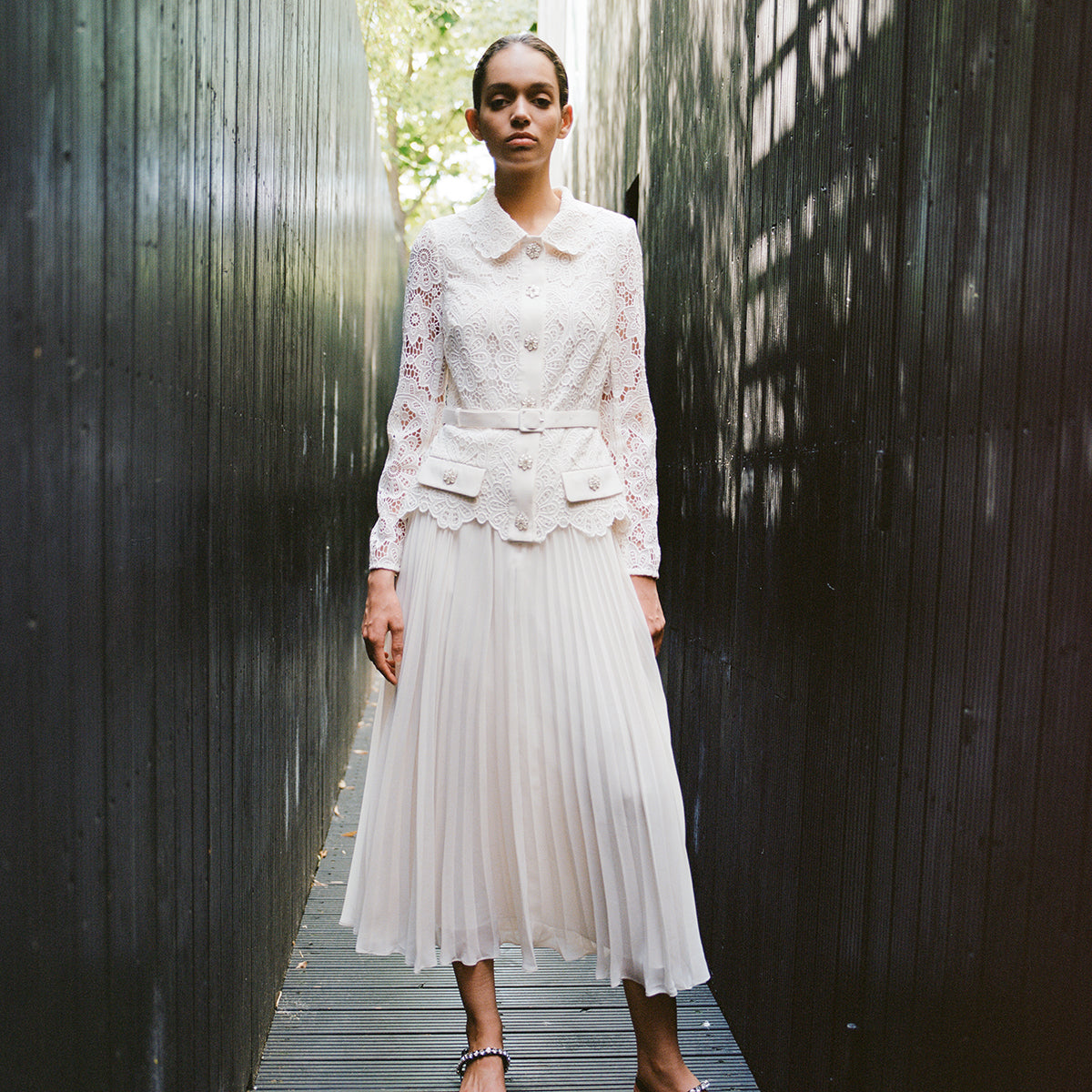 A woman wearing the Ivory Floral Motif Guipure Midi Dress