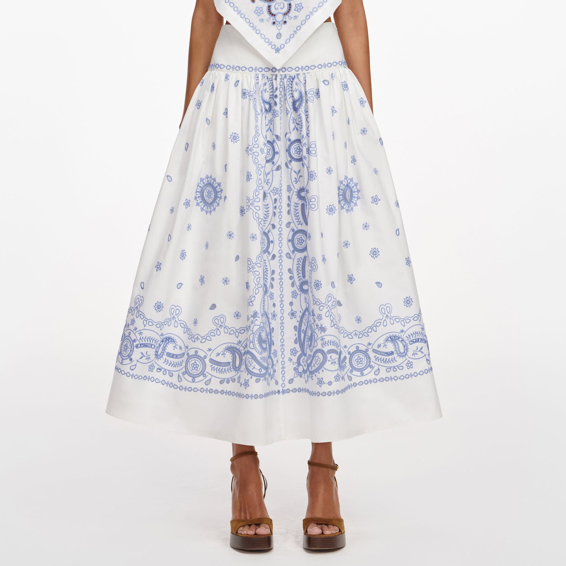 A close up of a woman wearing the White And Blue Embroidered Midi Skirt