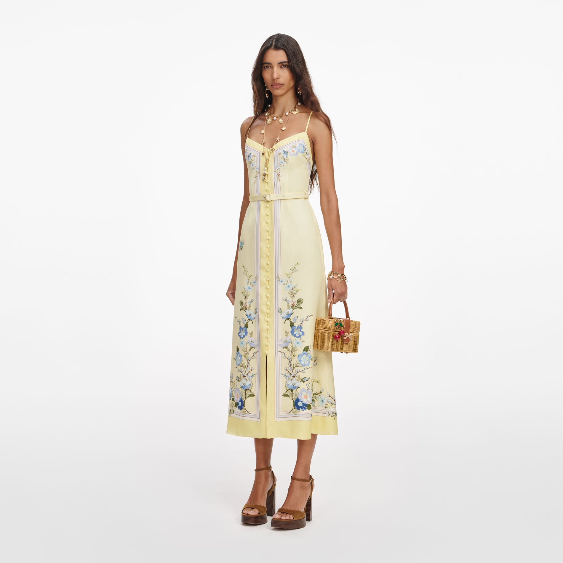 Side view of a woman wearing the Yellow Floral Silk Midi Dress