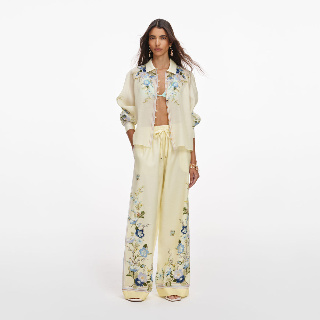 Front view of a woman wearing the Yellow Floral Organza Trousers
