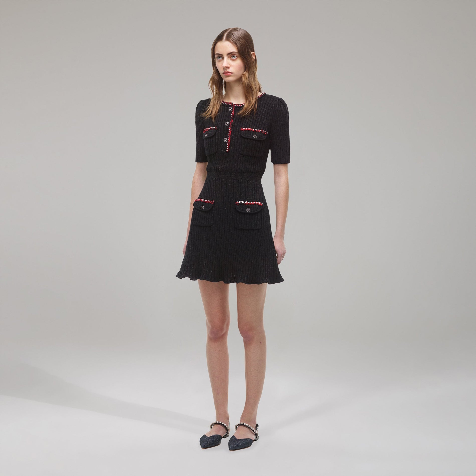 A woman wearing the Black Lurex Contrast Trim Mini Dress