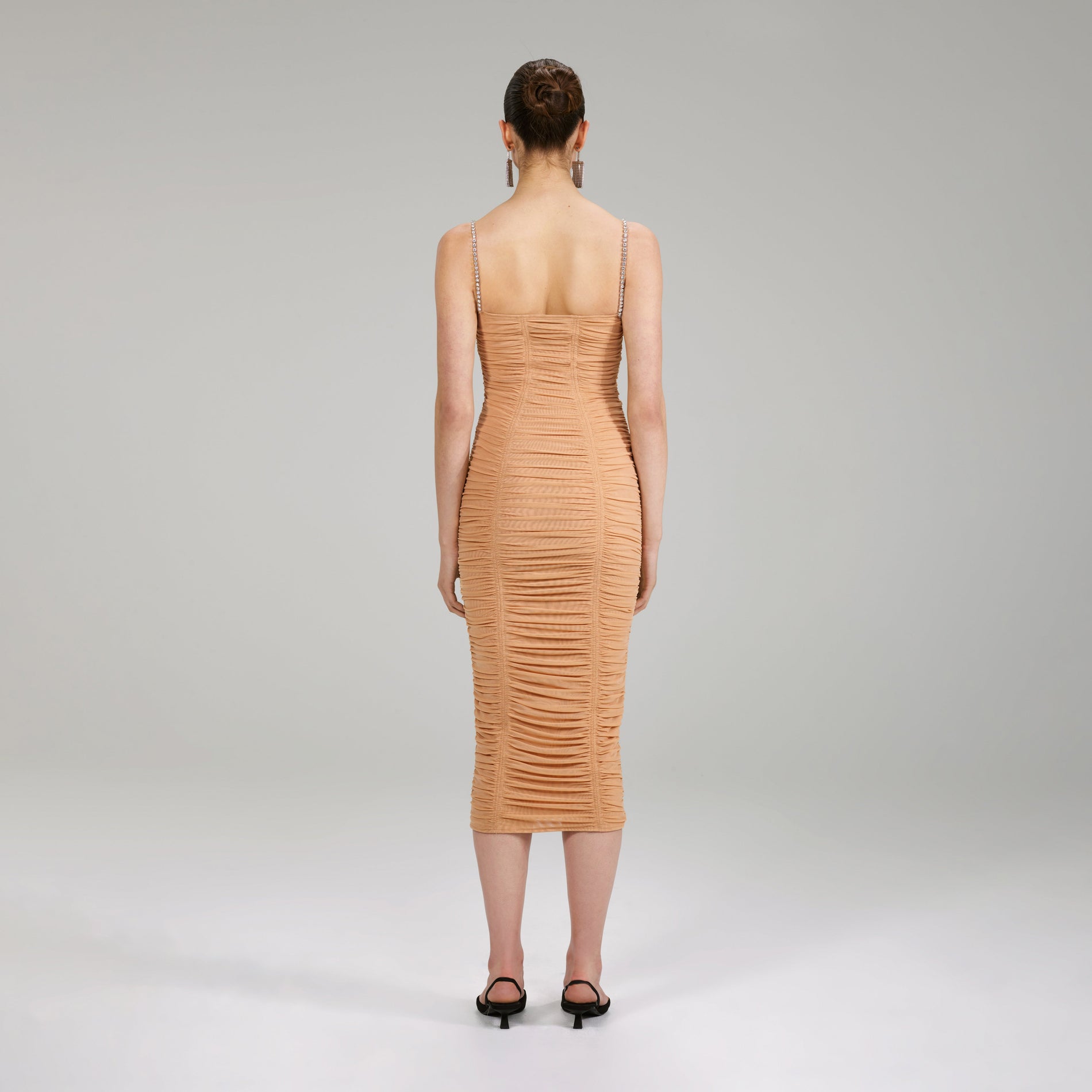 A woman wearing the Nude Power Mesh Midi Dress