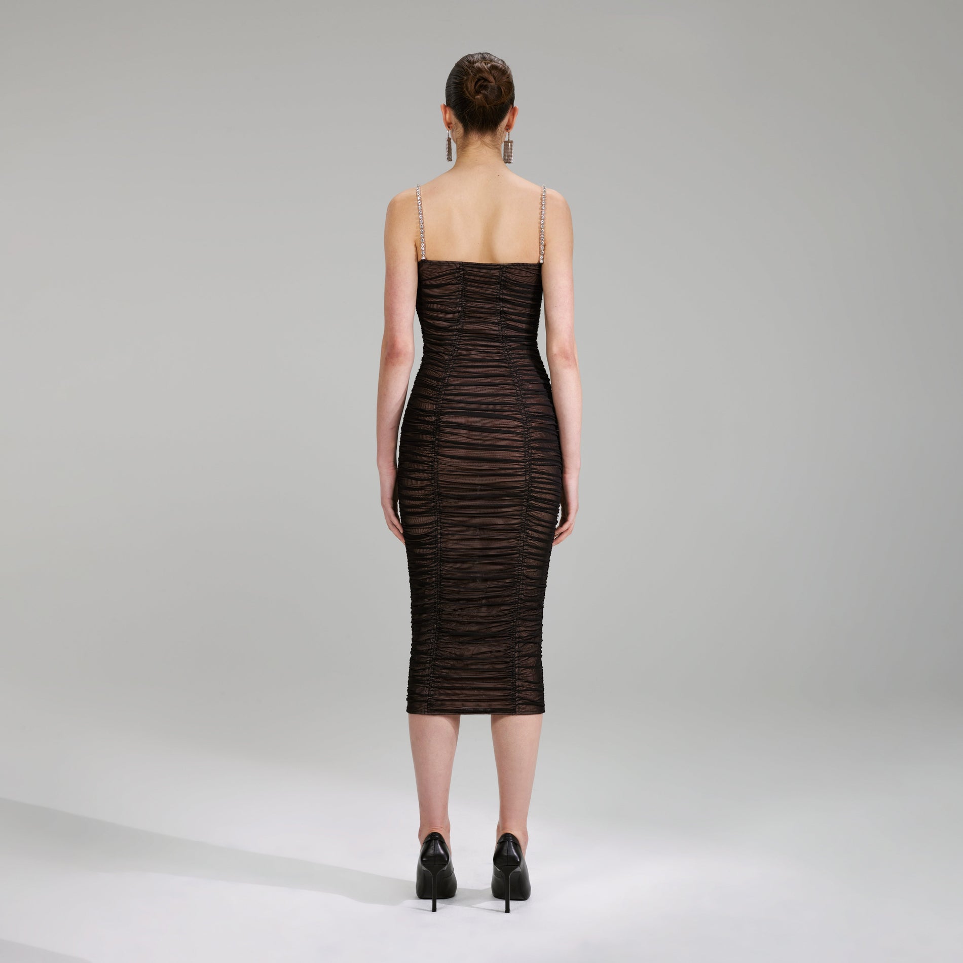 A woman wearing the Black Power Mesh Midi Dress