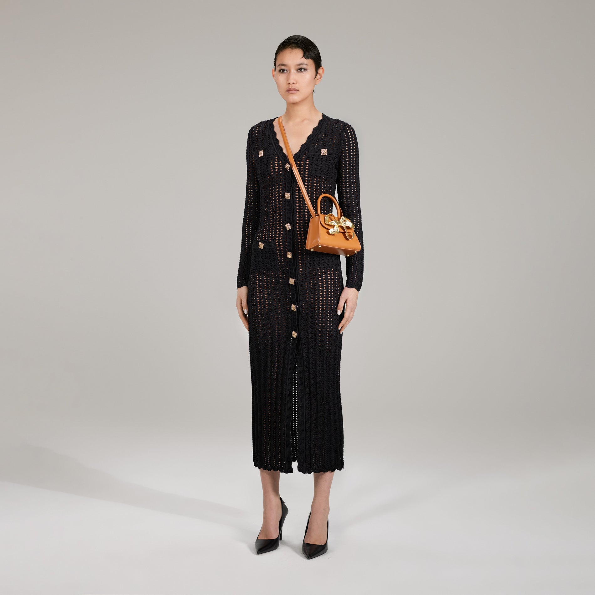 A woman wearing the Black Crochet Knit Dress