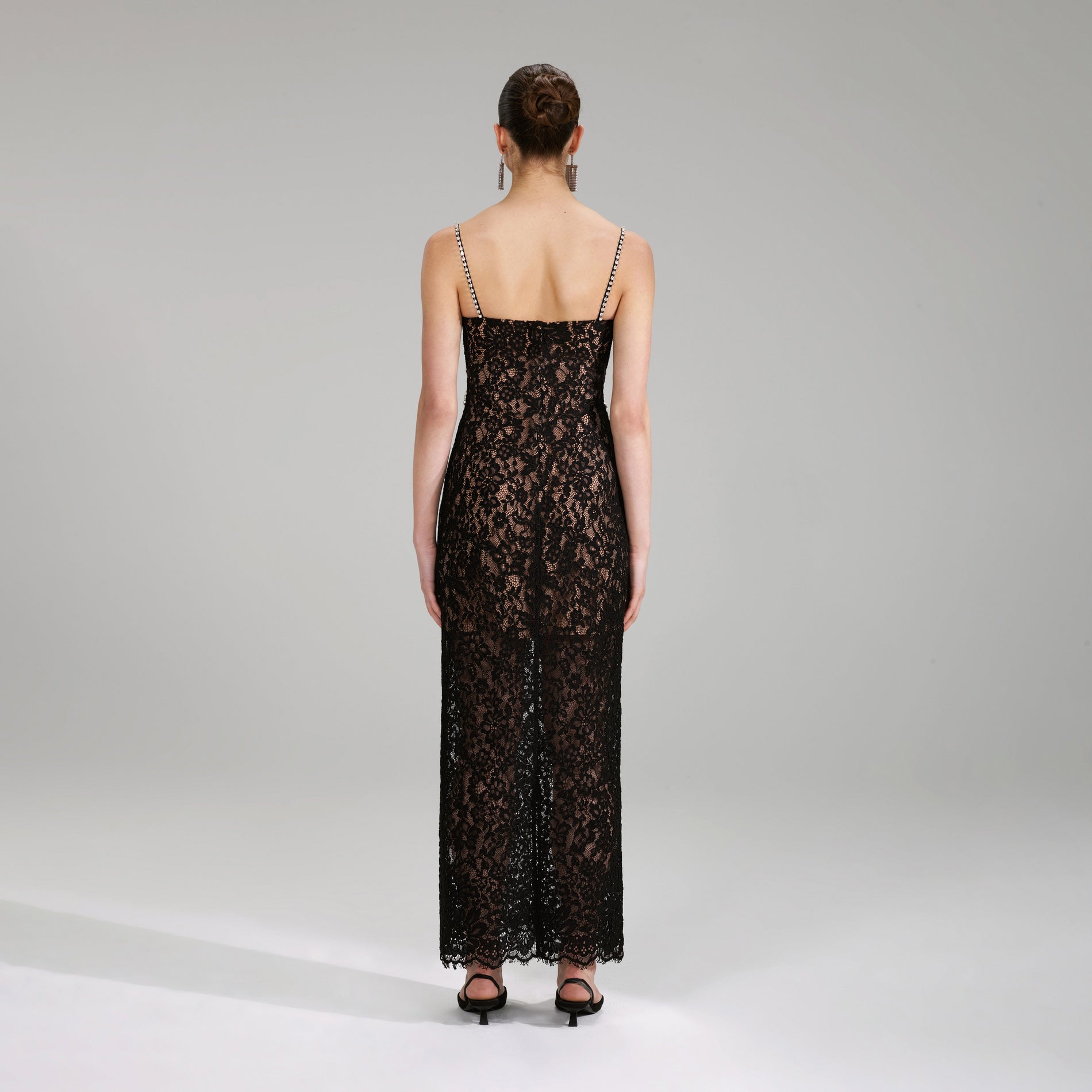 A woman wearing the Black Fine Lace Maxi Dress