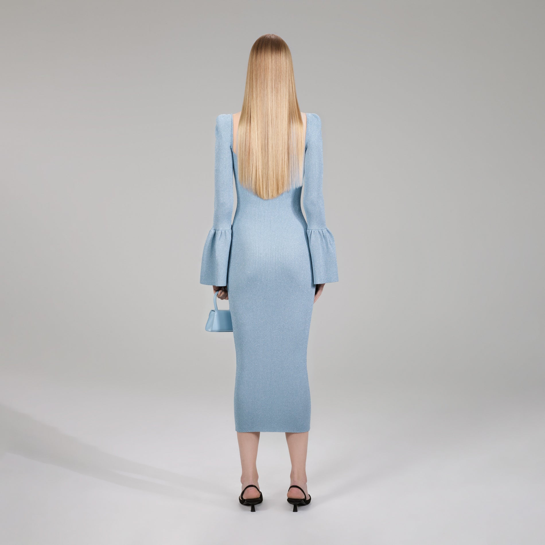 A woman wearing the Light Blue Lurex Knit Midi Dress