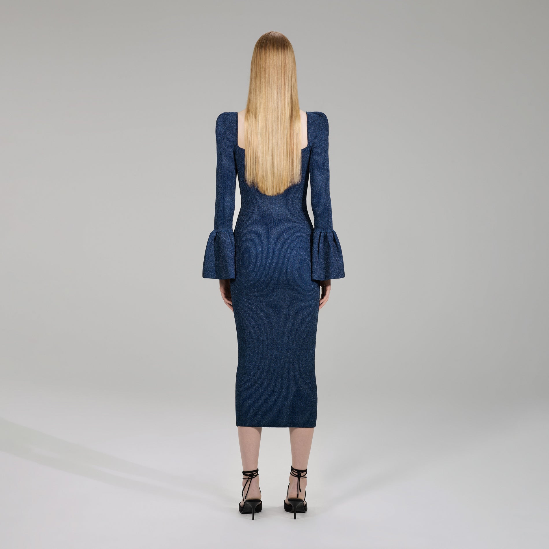 A woman wearing the Dark Blue Lurex Knit Midi Dress