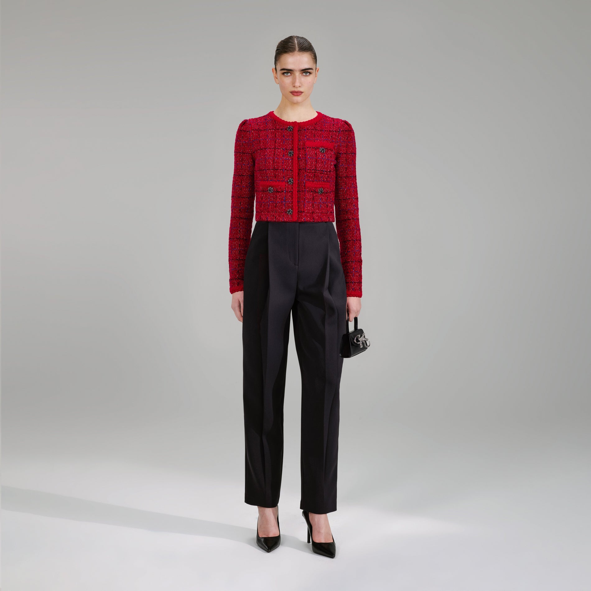 A woman wearing the Red Melange Knit Jacket