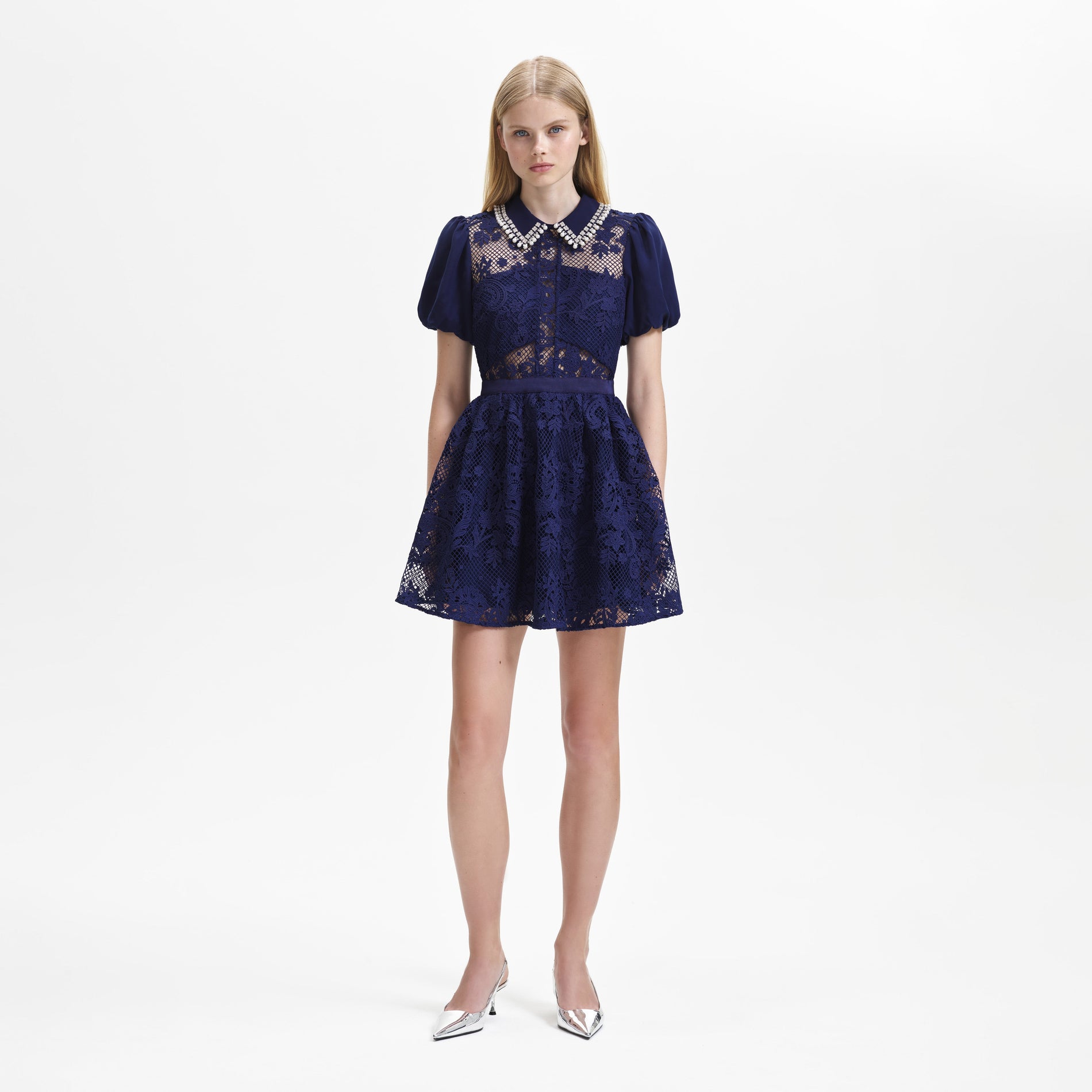 A woman wearing the Navy Lace Diamante Collar Mini Dress