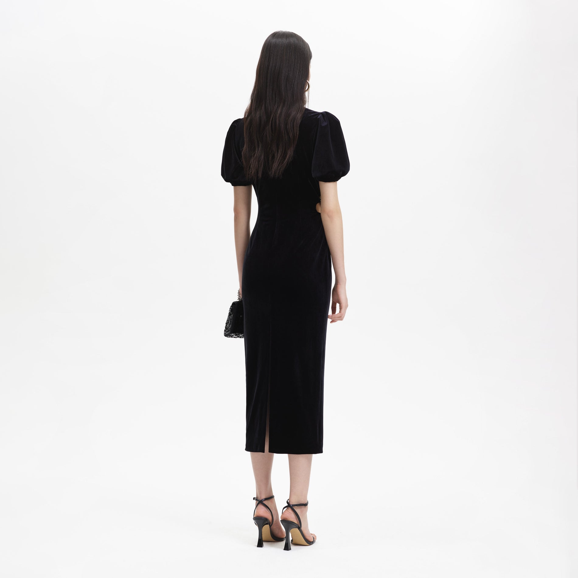 Back view of a woman wearing the Black Velvet Cut Out Midi Dress