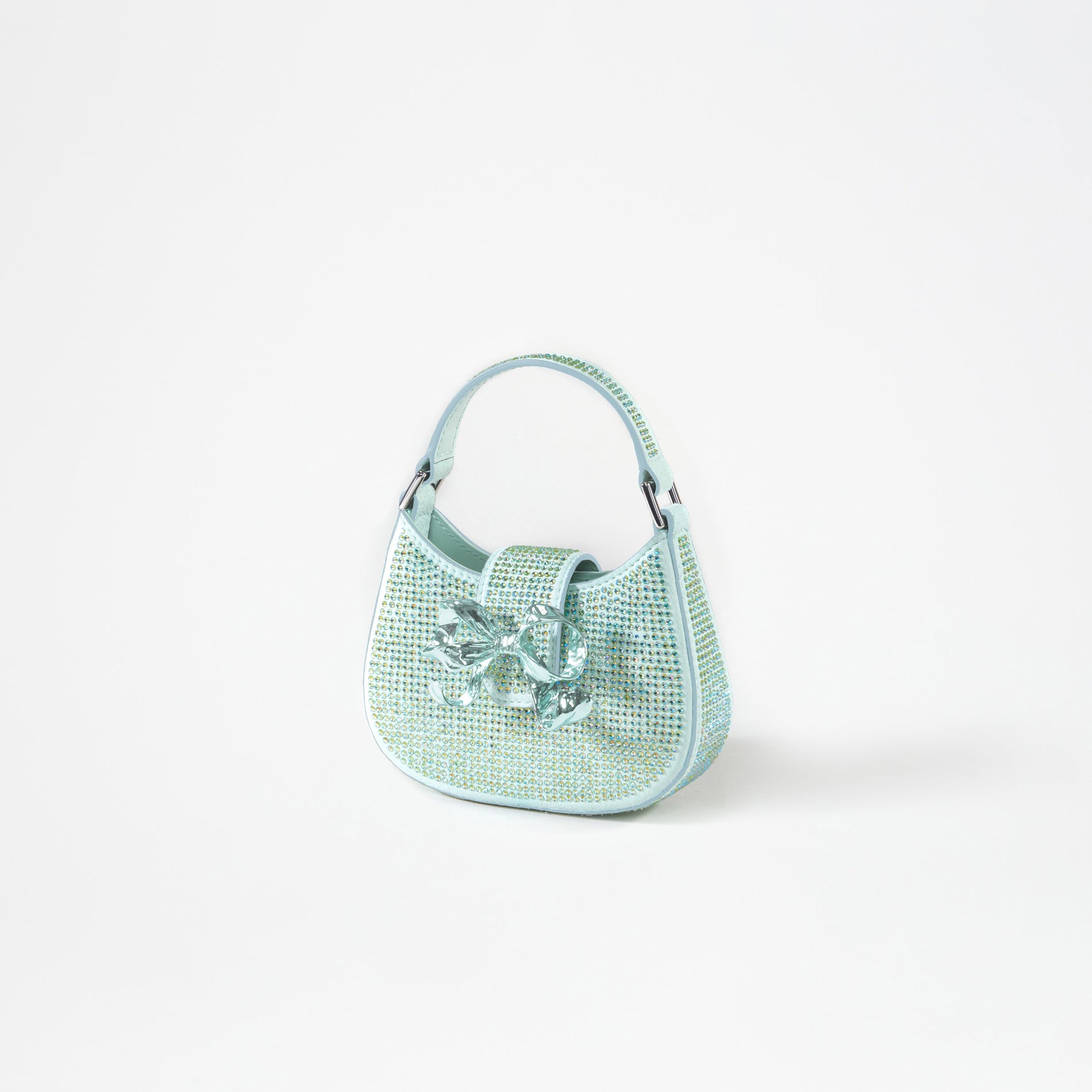 A woman wearing the Green Rhinestone Crescent Bow Micro Bag