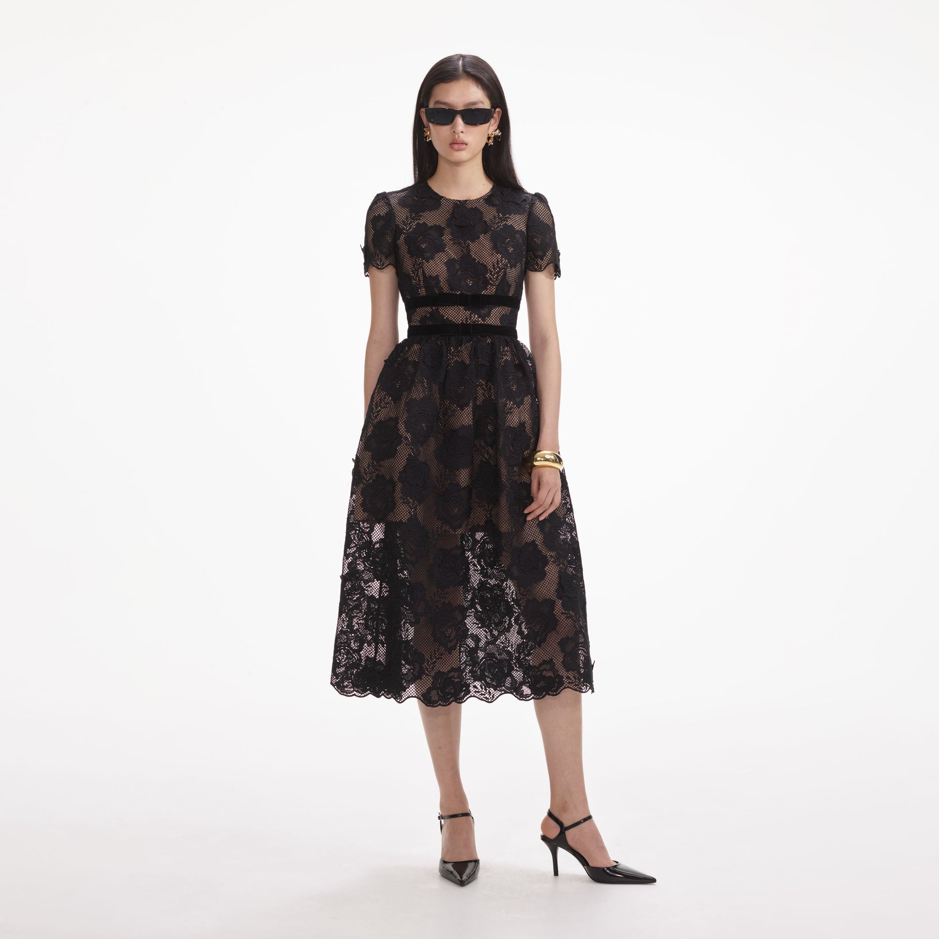 Side view of a woman wearing the Black Lace Velvet Bow Midi Dress