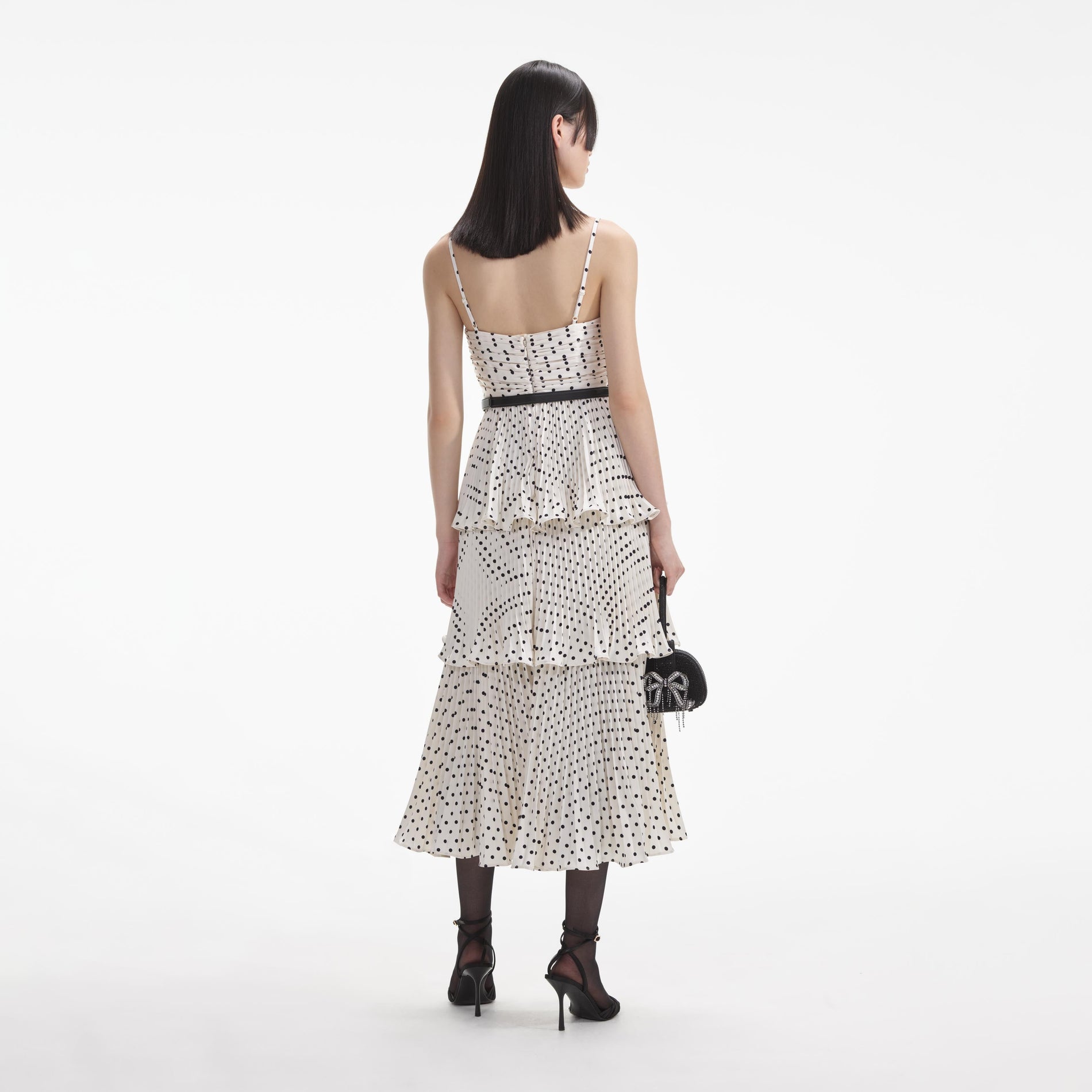 Back view of a woman wearing the White Cream Polka Dot Tiered Midi Dress