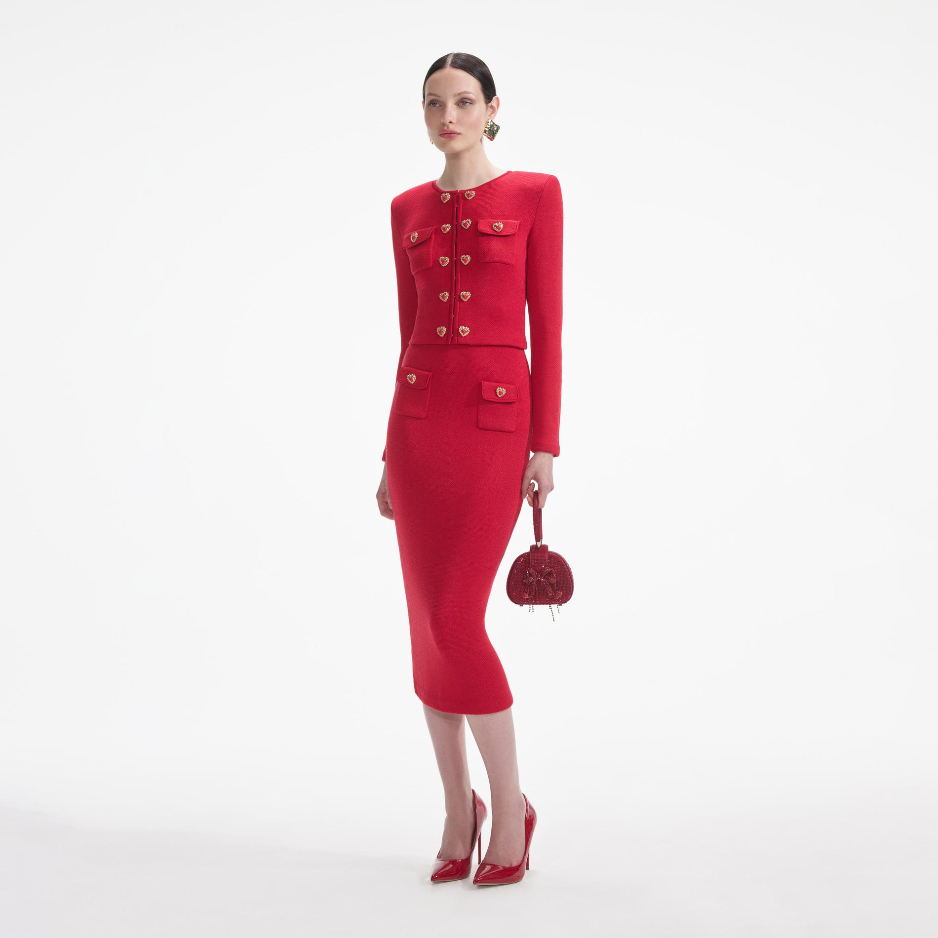 Side view of a woman wearing the Red Knit Heart Buttoned Cardigan