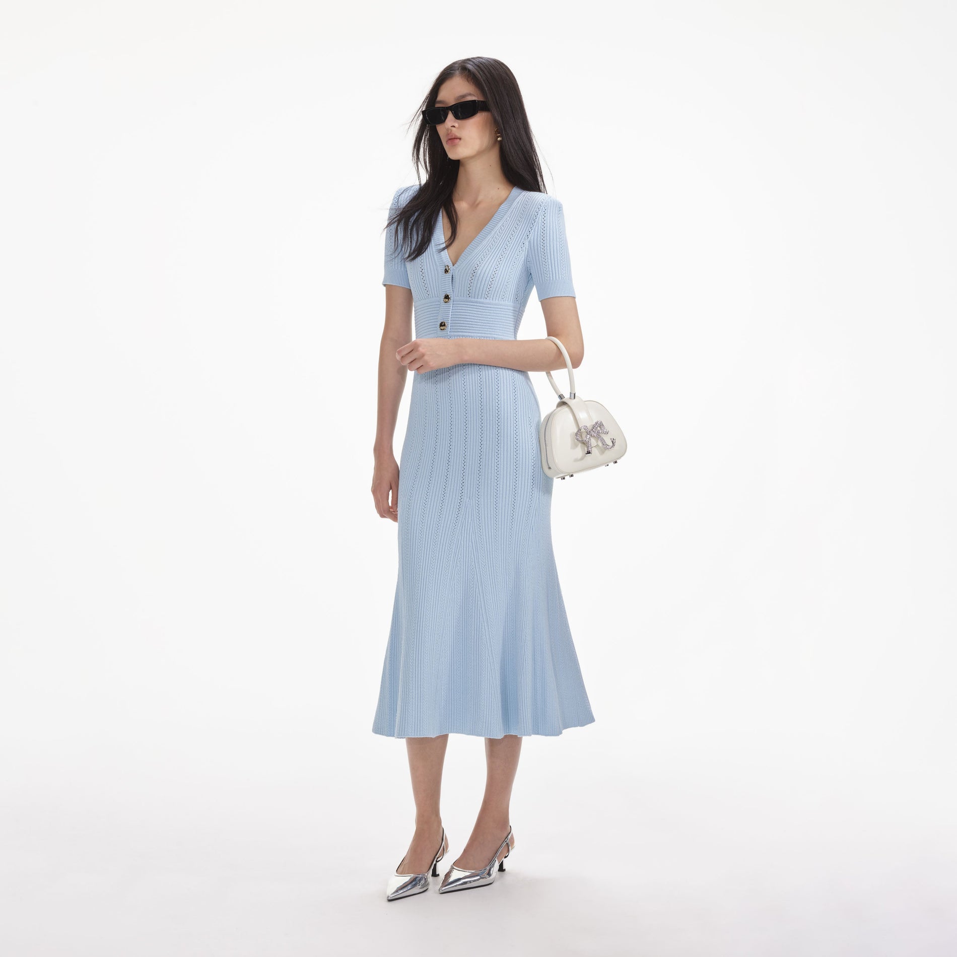 Side view of a woman wearing the Blue Pointelle Knit Midi Dress