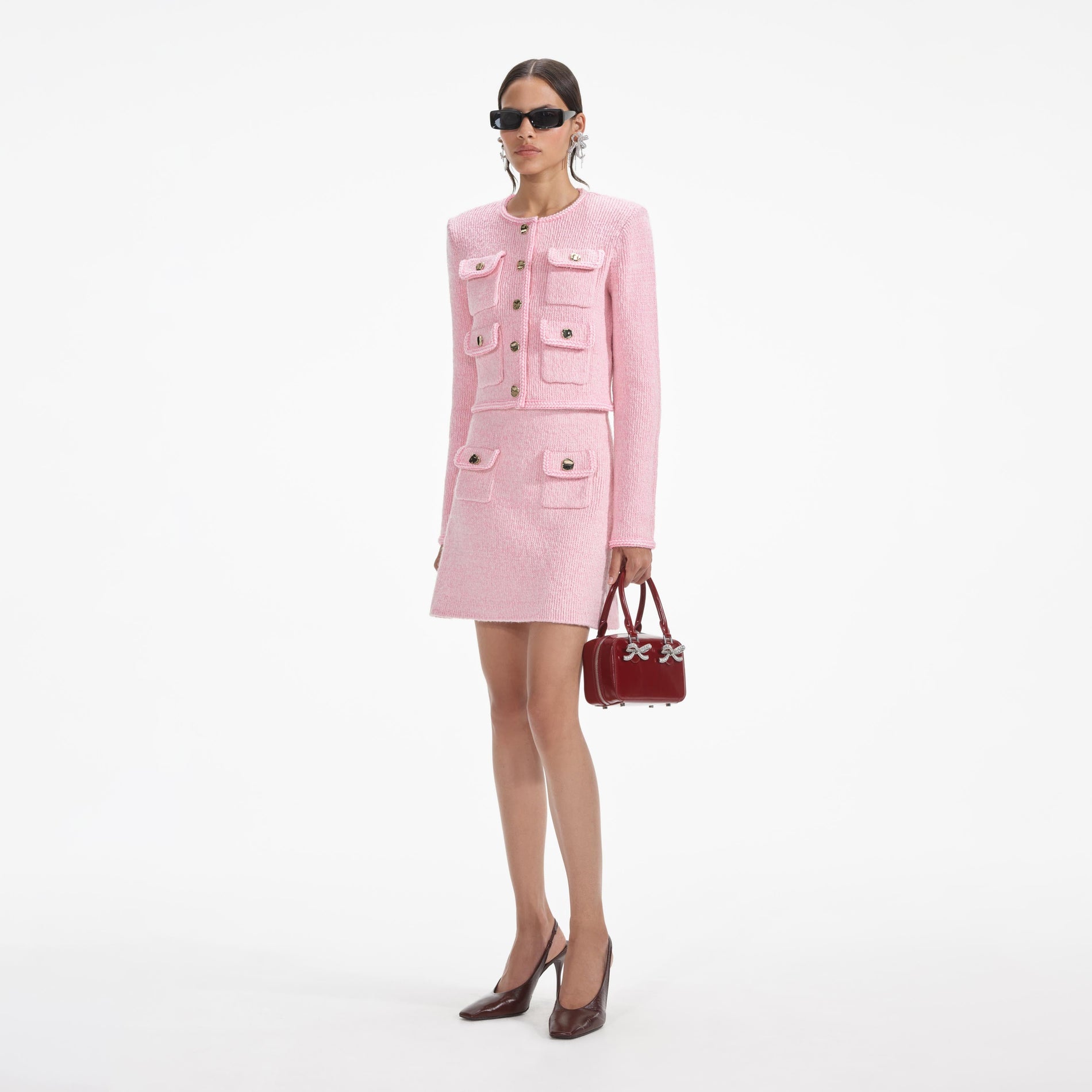 Side view of a woman wearing the Pink Melange Merino Knit Skirt