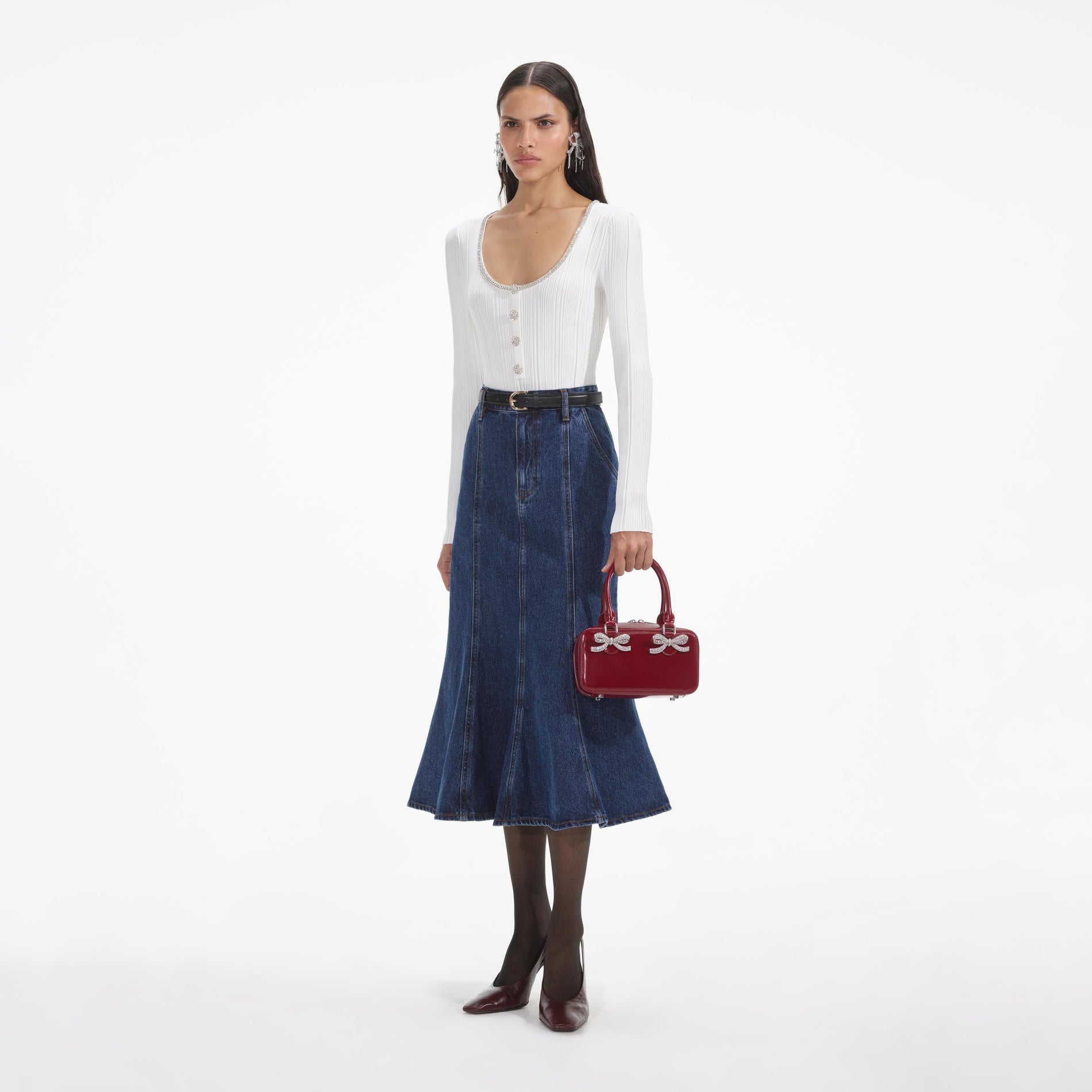 Side view of a woman wearing the White Embellished Knit Top