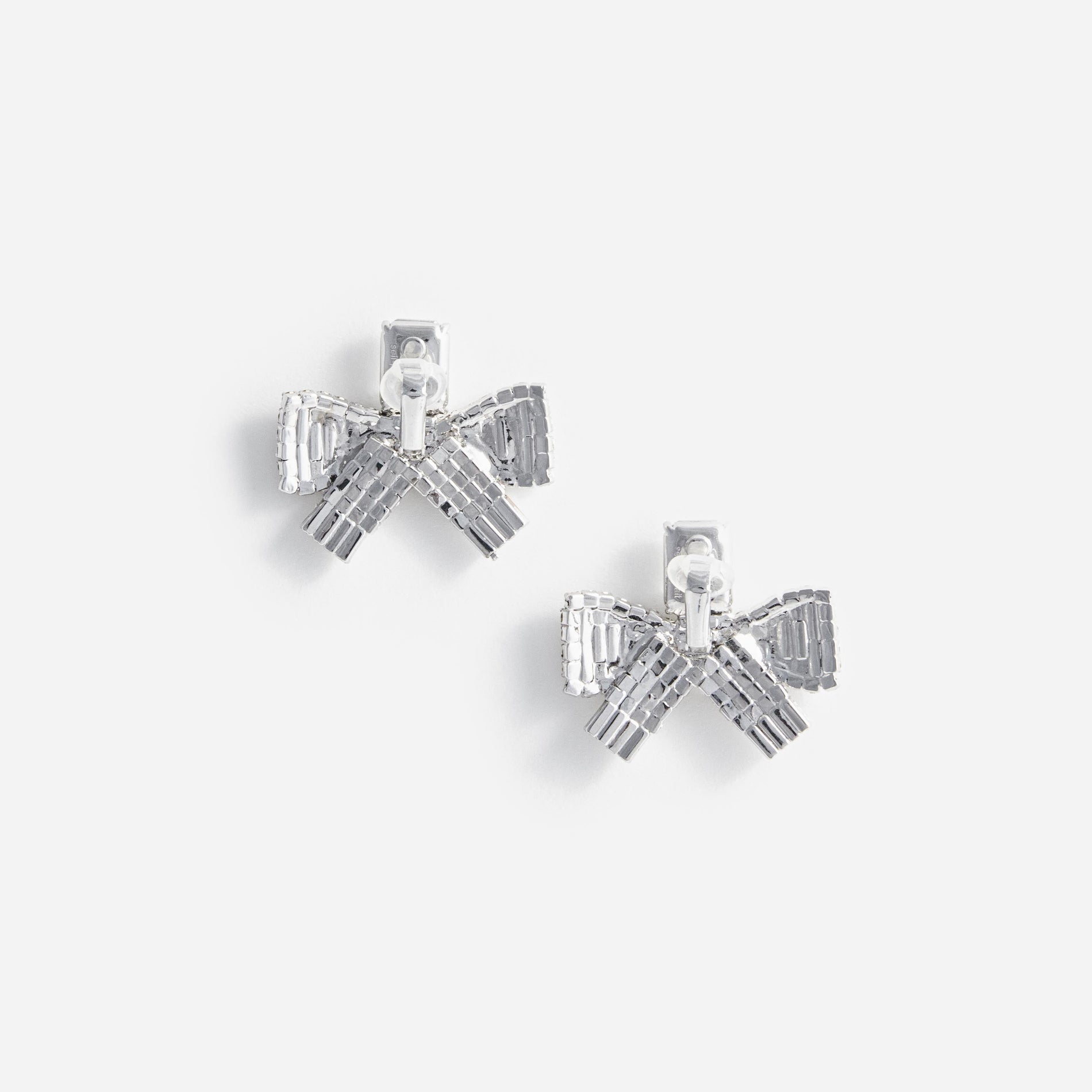 Side view of a woman wearing the Small Crystal Bow Earrings