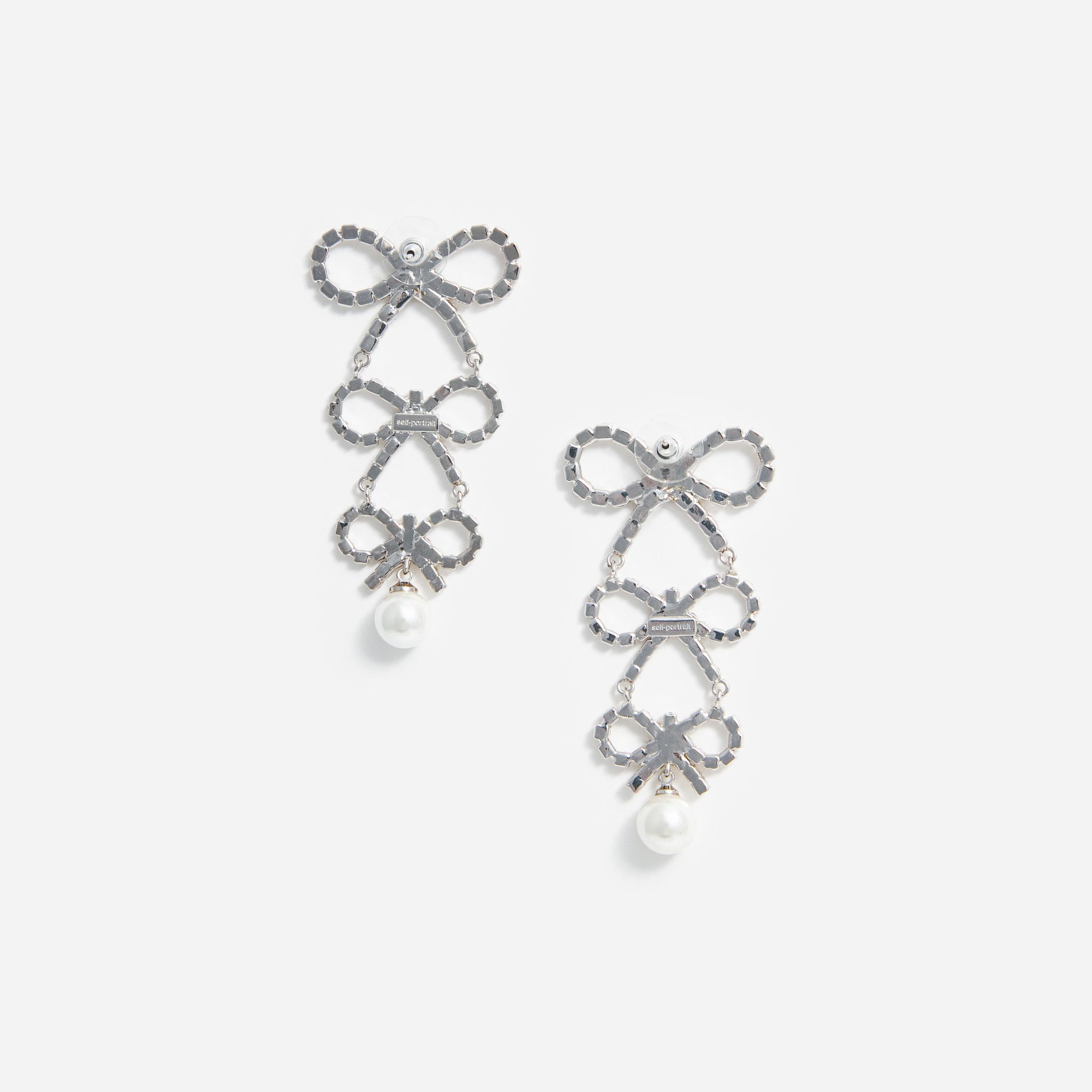 Side view of a woman wearing the Tiered Crystal Bow Earrings