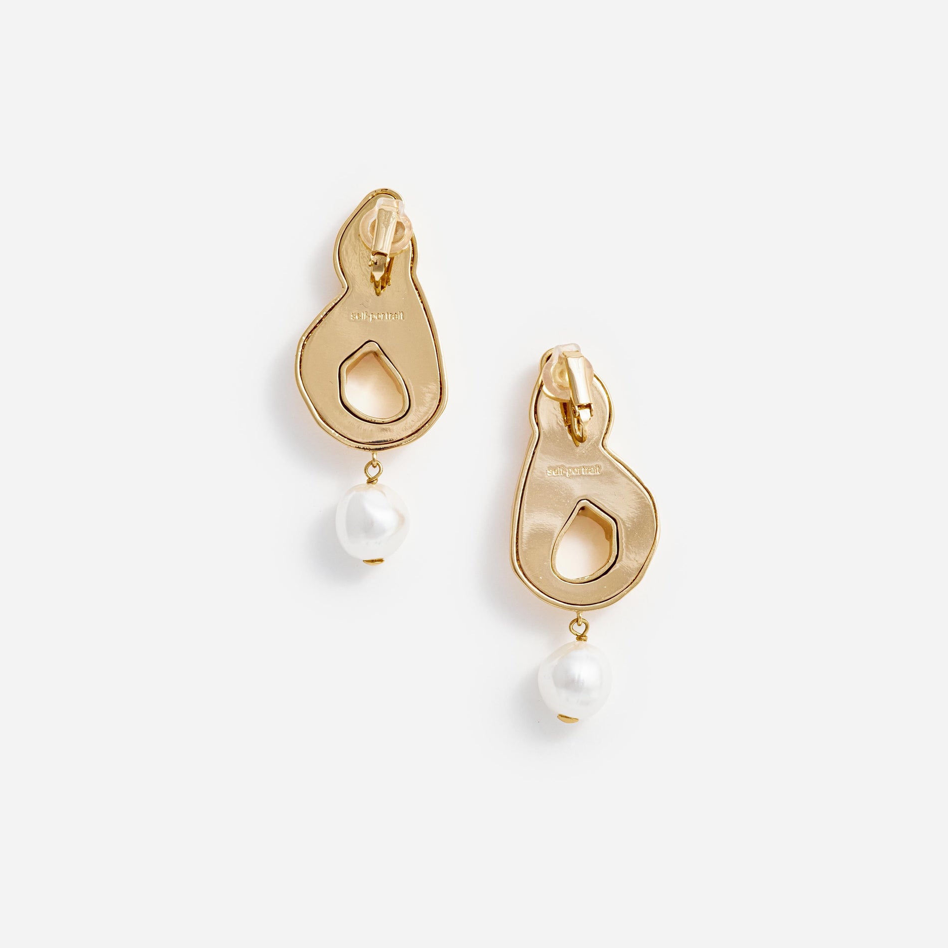 Side view of a woman wearing the Gold Faux Pearl Drop Earrings
