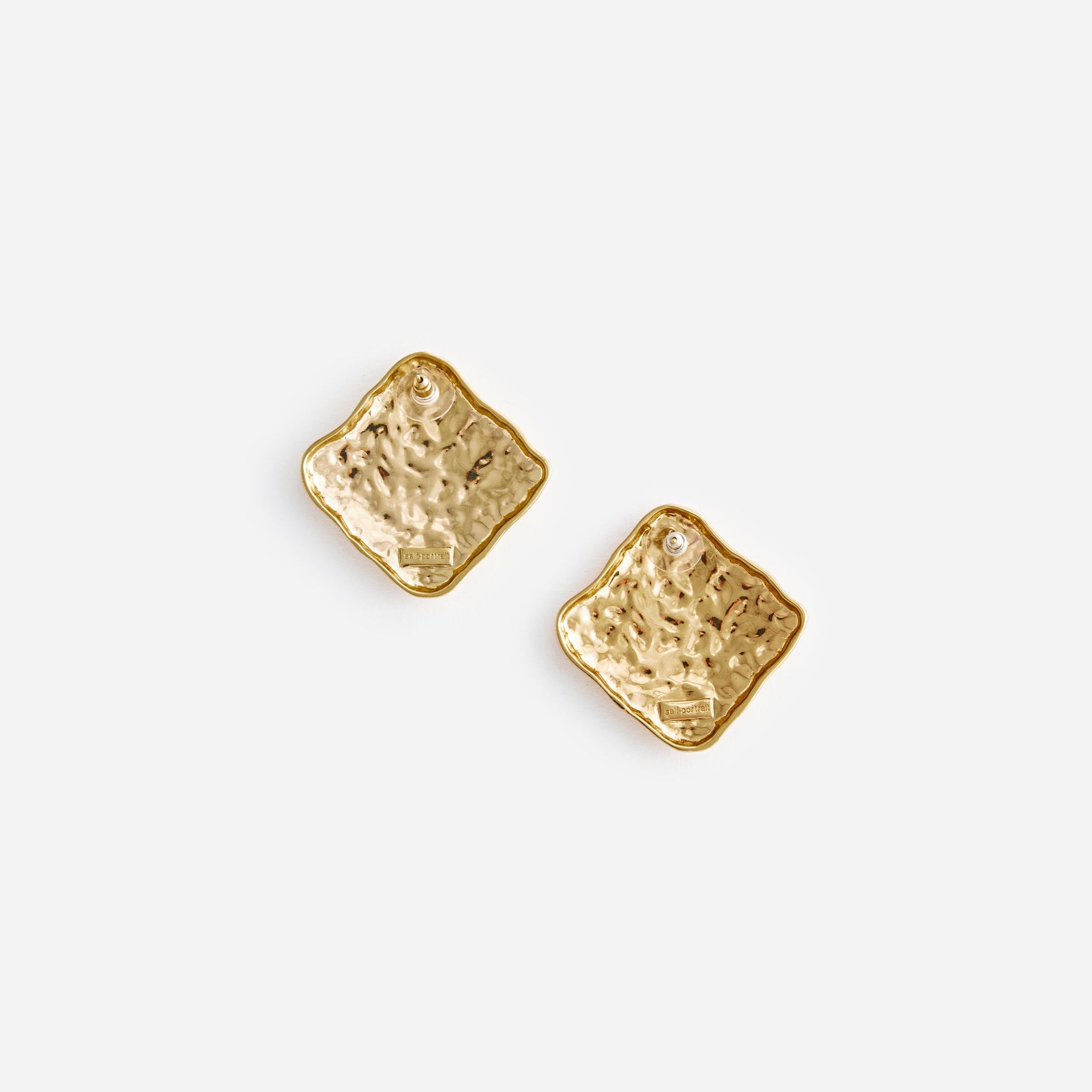 Side view of a woman wearing the Textured Gold Square Earrings