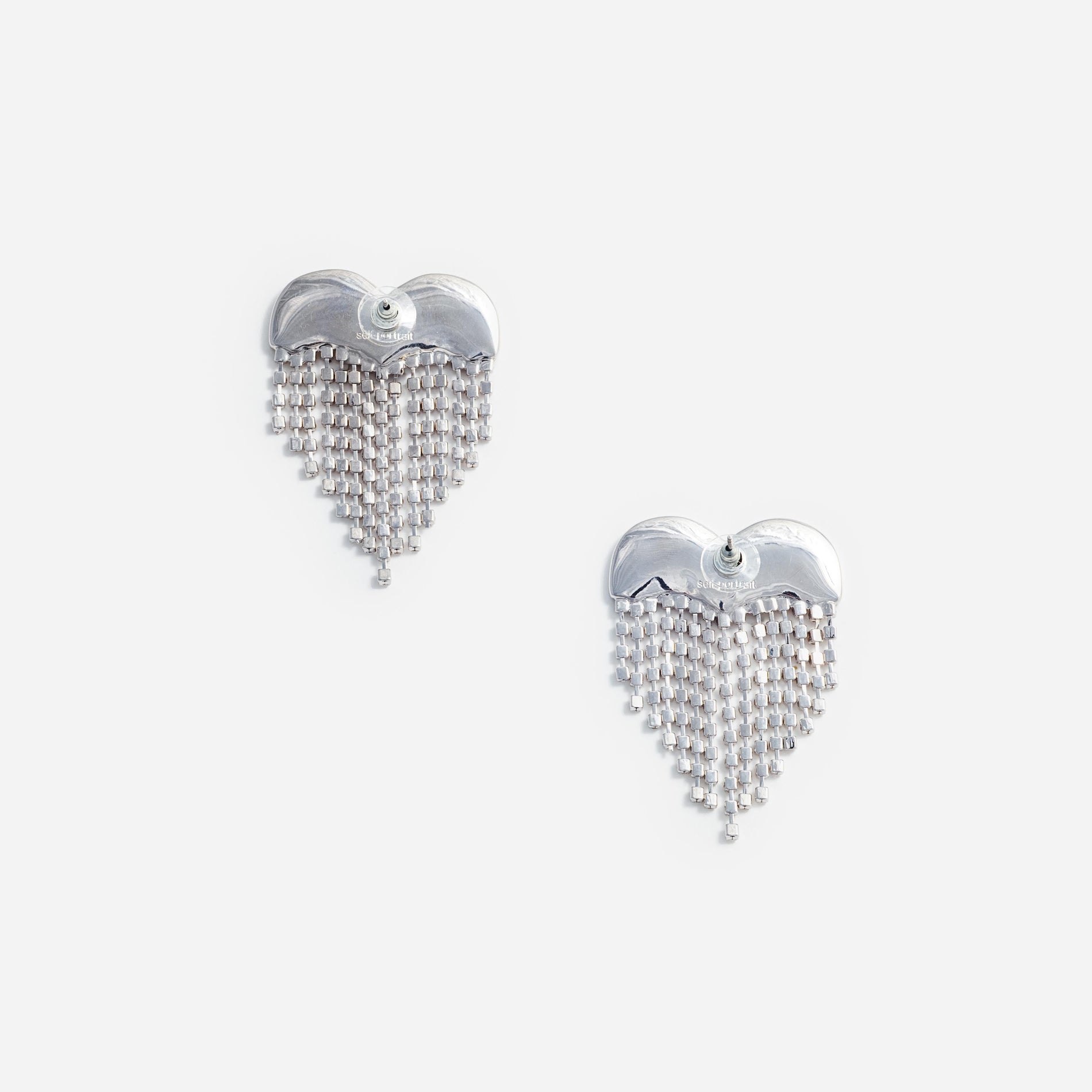 Side view of a woman wearing the Crystal Heart Earrings