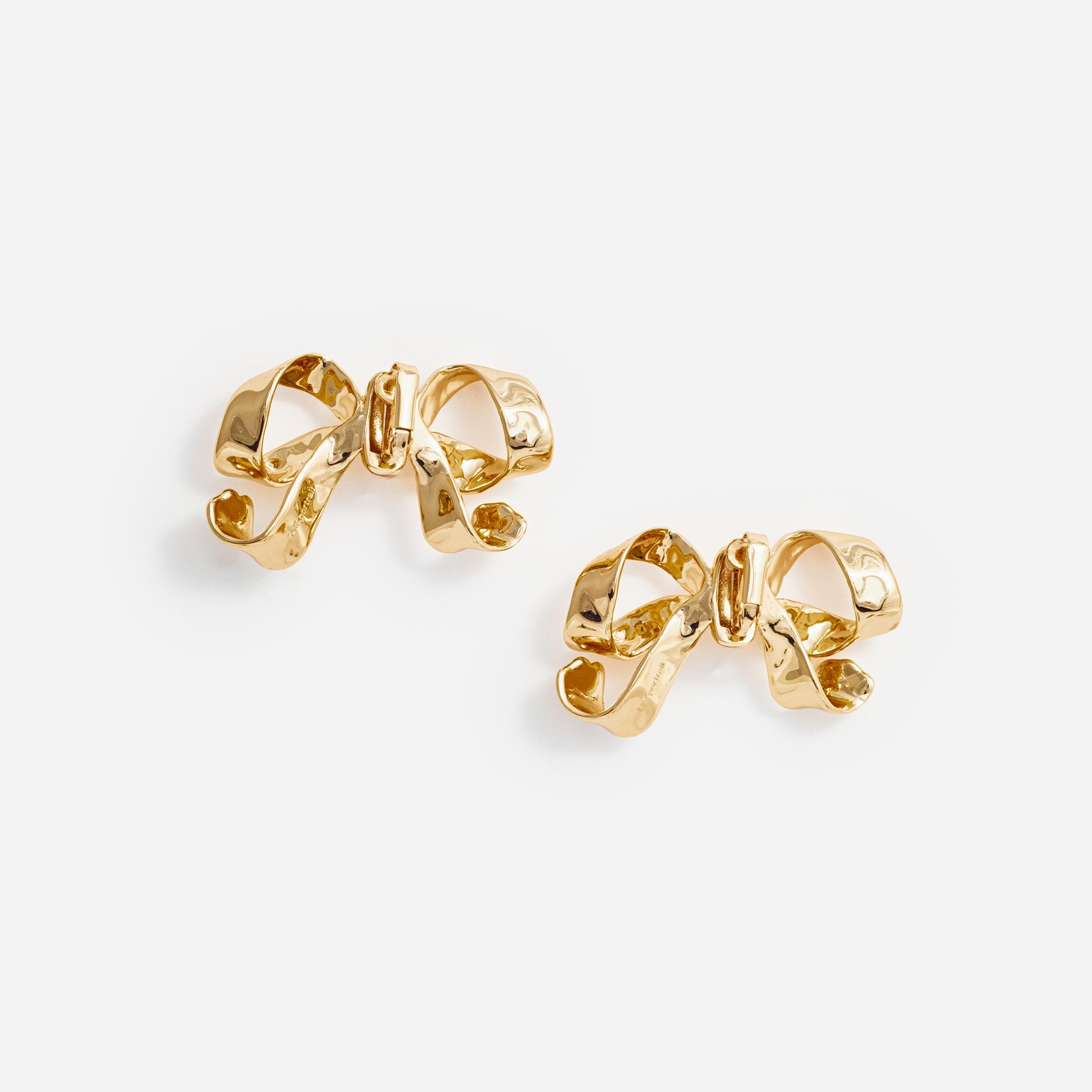 Side view of a woman wearing the Gold Bow Earrings