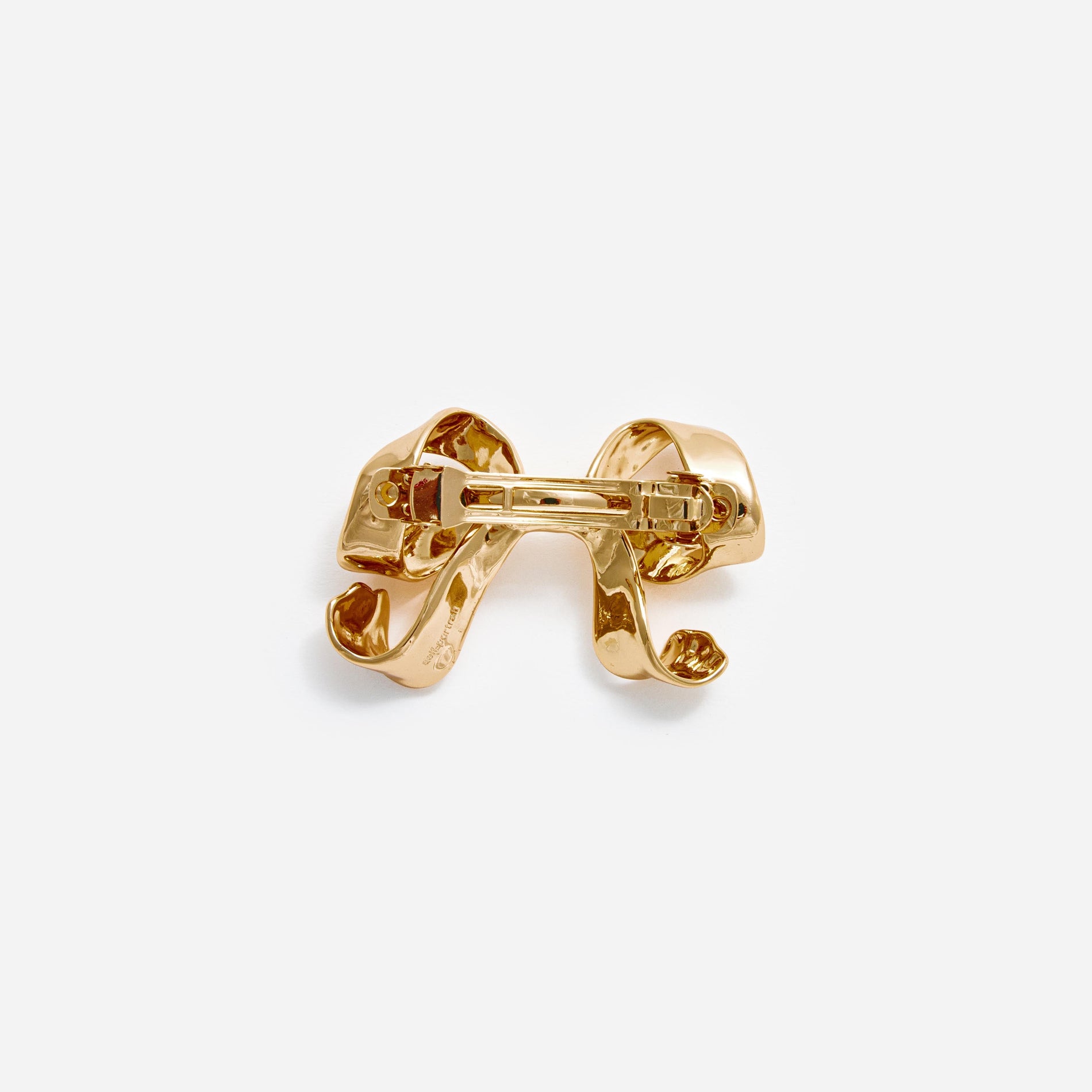 Side view of a woman wearing the Gold Bow Hair Clip