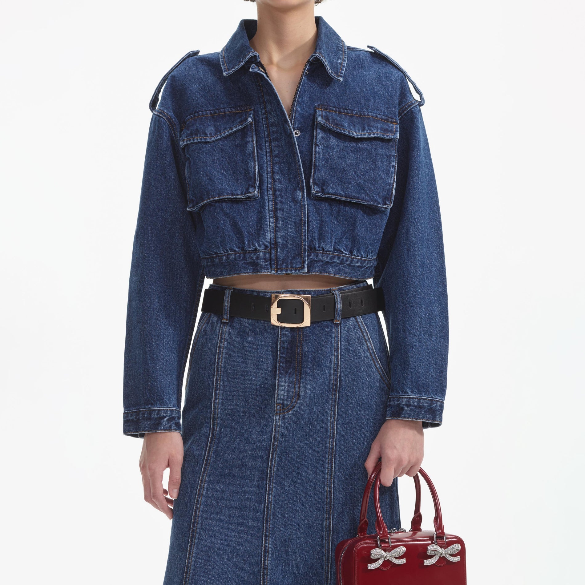 A close up of a woman wearing the Denim Utility Cropped Jacket