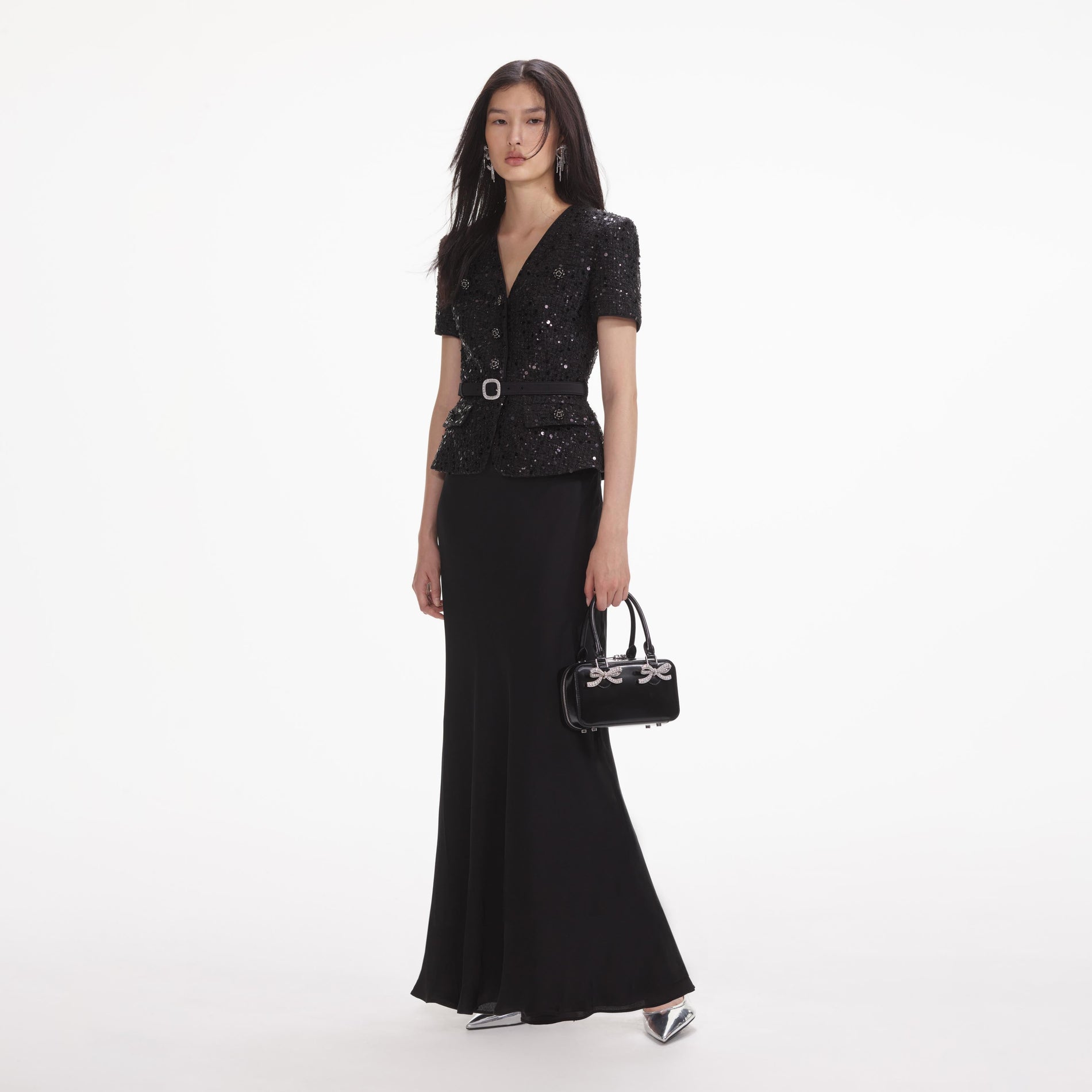 Side view of a woman wearing the Black Sequin Boucle Maxi Dress