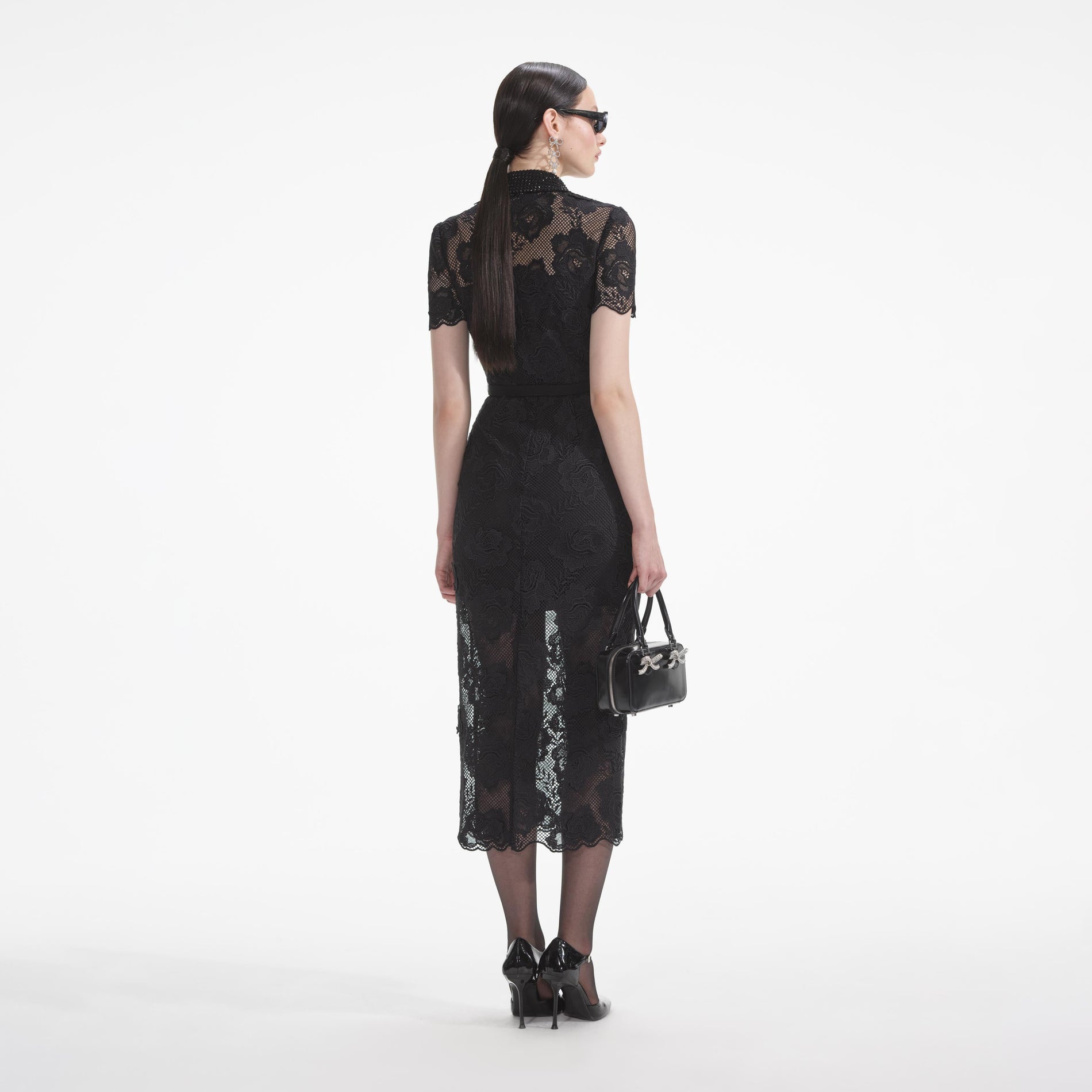 Back view of a woman wearing the White Black Lace Diamante Midi Dress