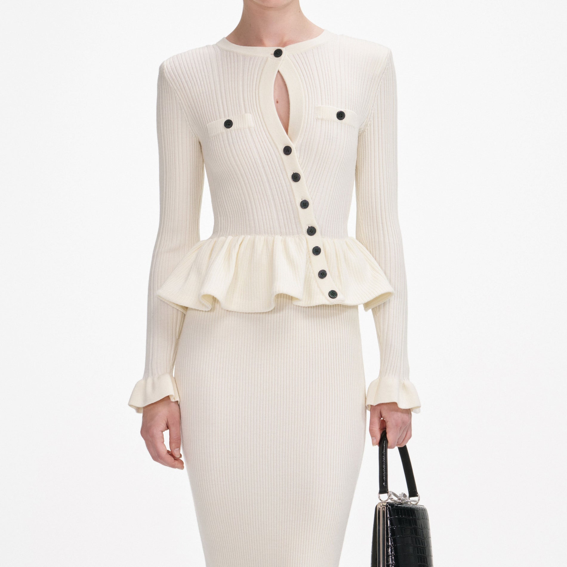 A close up of a woman wearing the Cream Asymmetric Knit Midi Dress