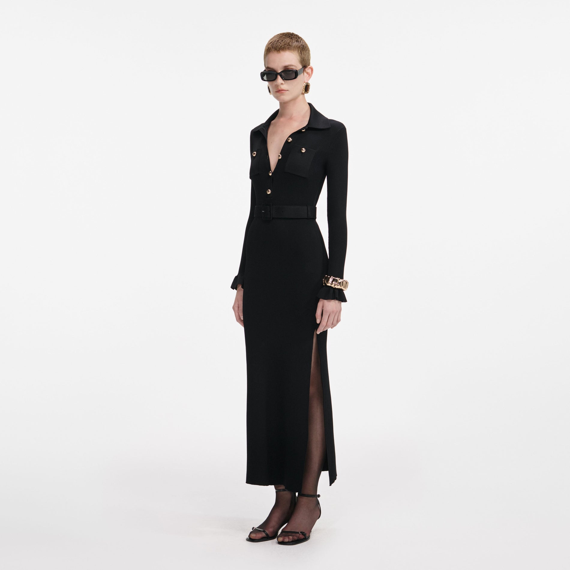 Side view of a woman wearing the Black Ribbed Knit Maxi Dress