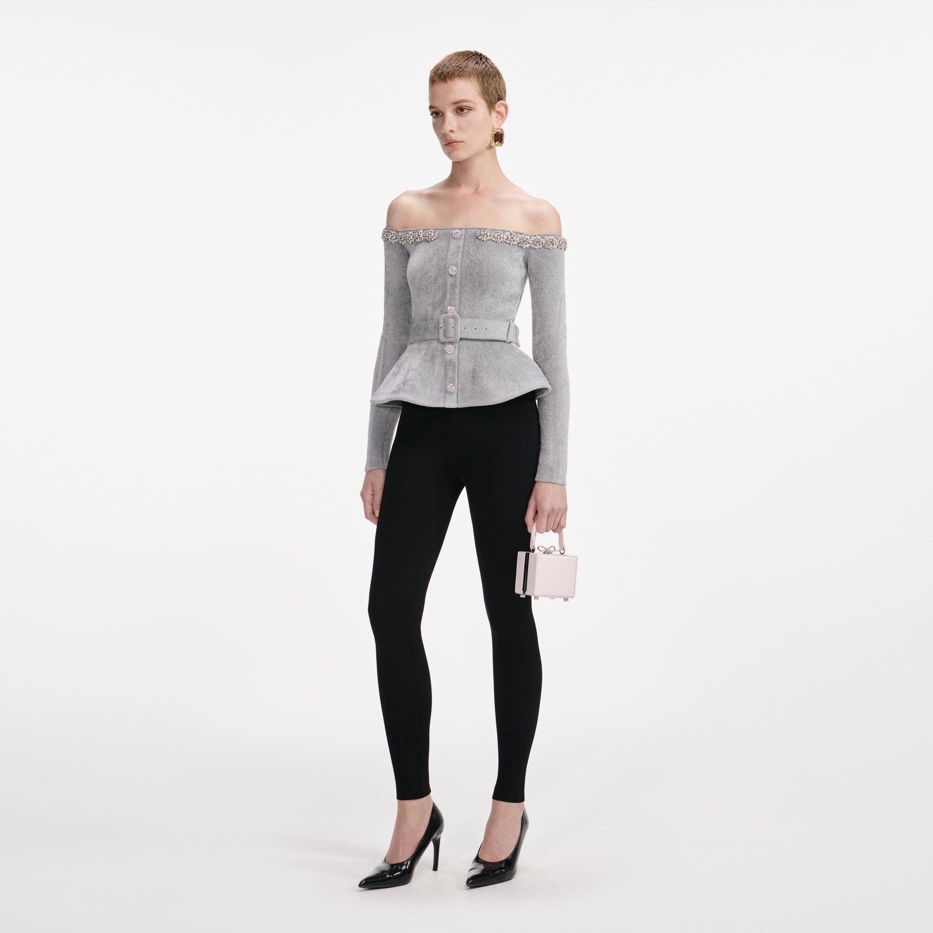 Side view of a woman wearing the Grey Chenille Knit Crystal Trim Top