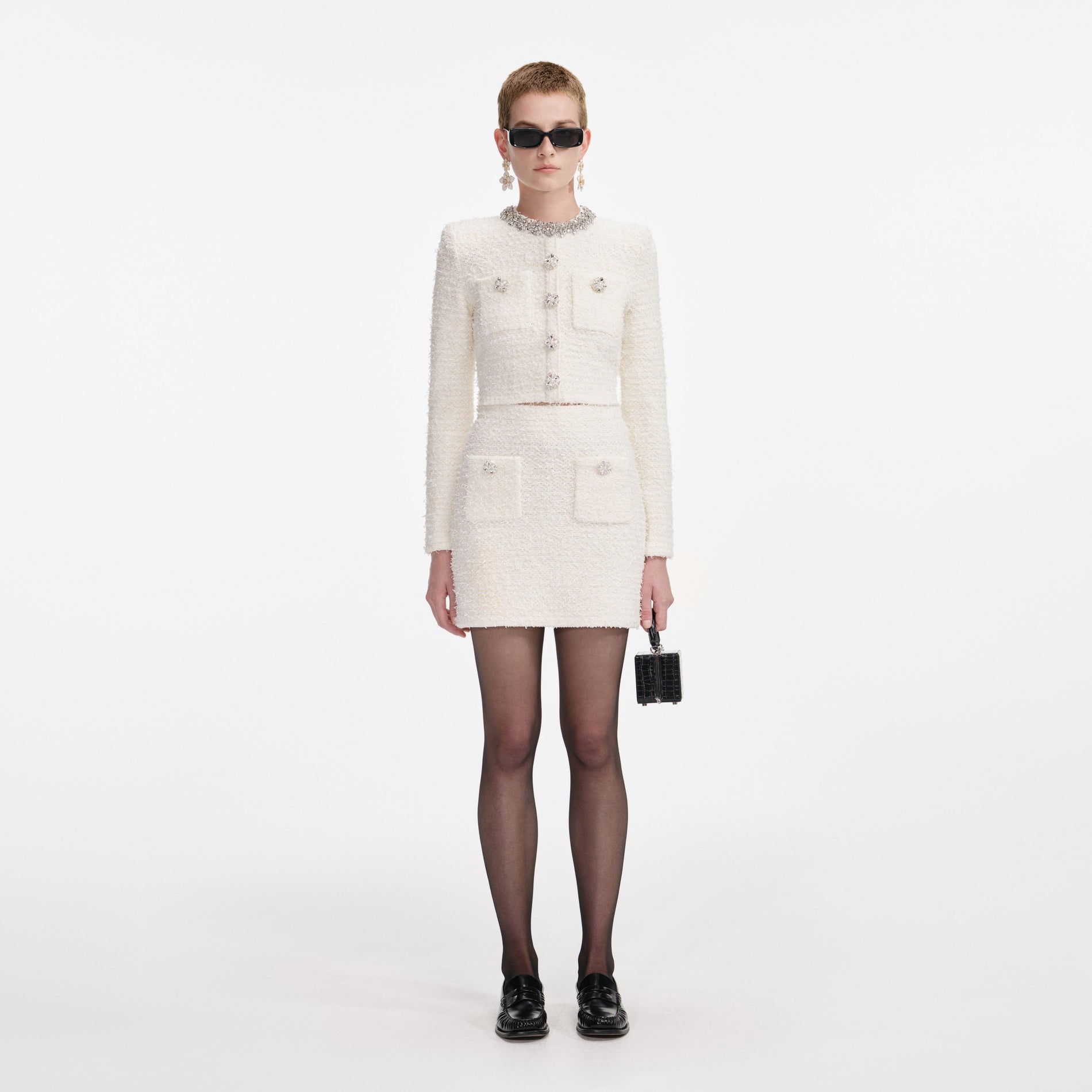 Front view of a woman wearing the Cream Textured Knit Mini Skirt