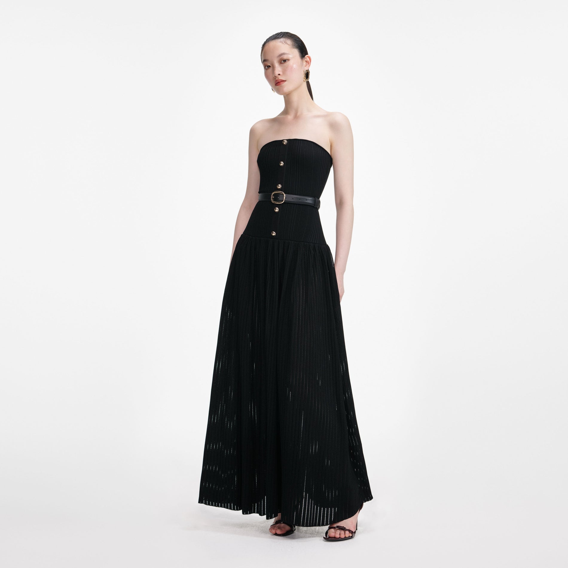 Side view of a woman wearing the Black Bandeau Knit Maxi Dress