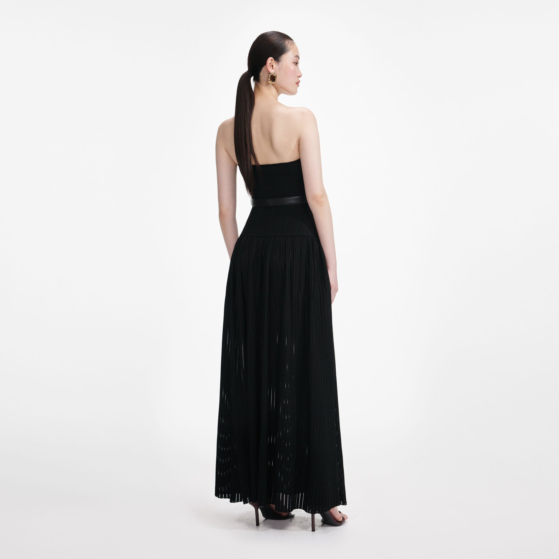 Back view of a woman wearing the Black Bandeau Knit Maxi Dress
