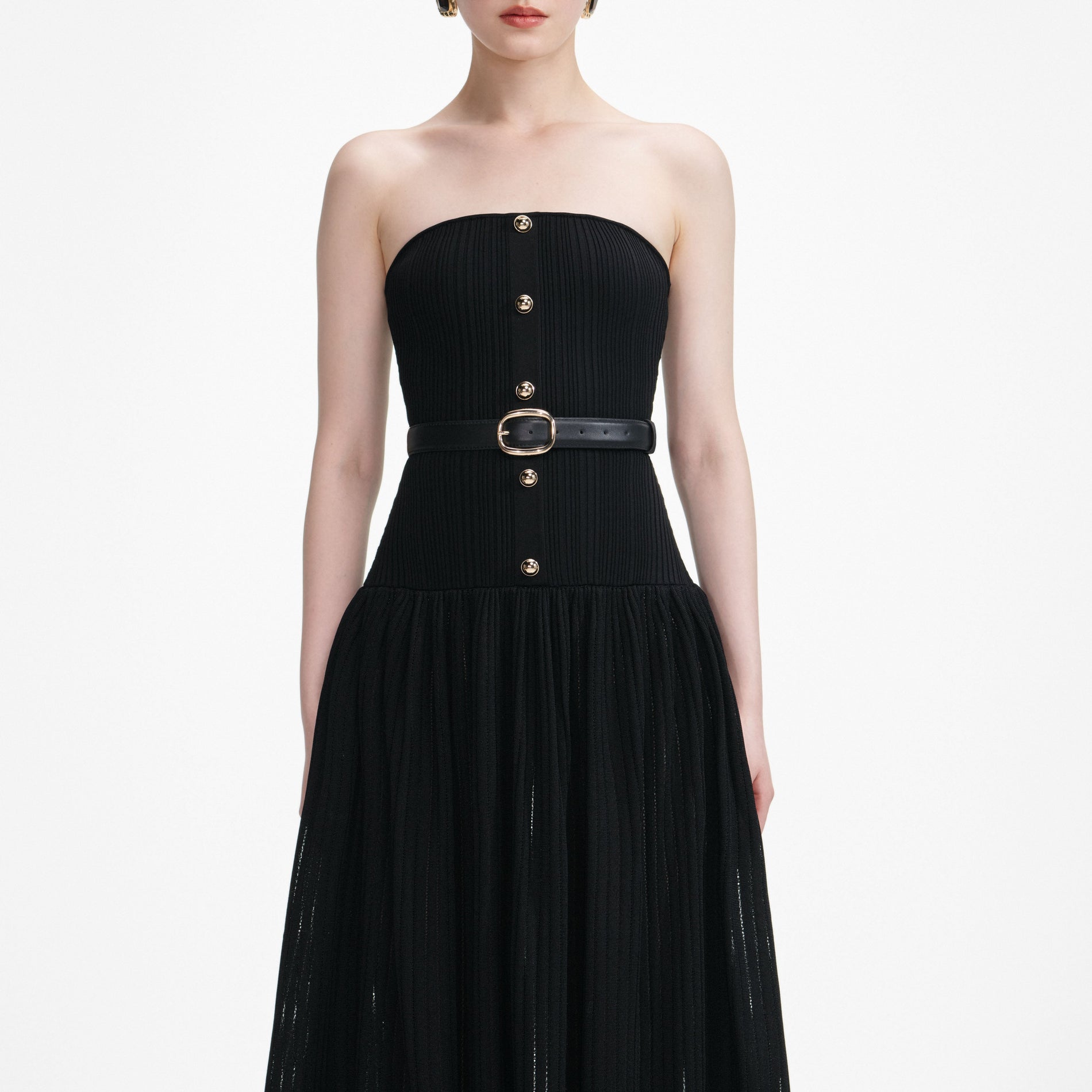 A close up of a woman wearing the Black Bandeau Knit Maxi Dress