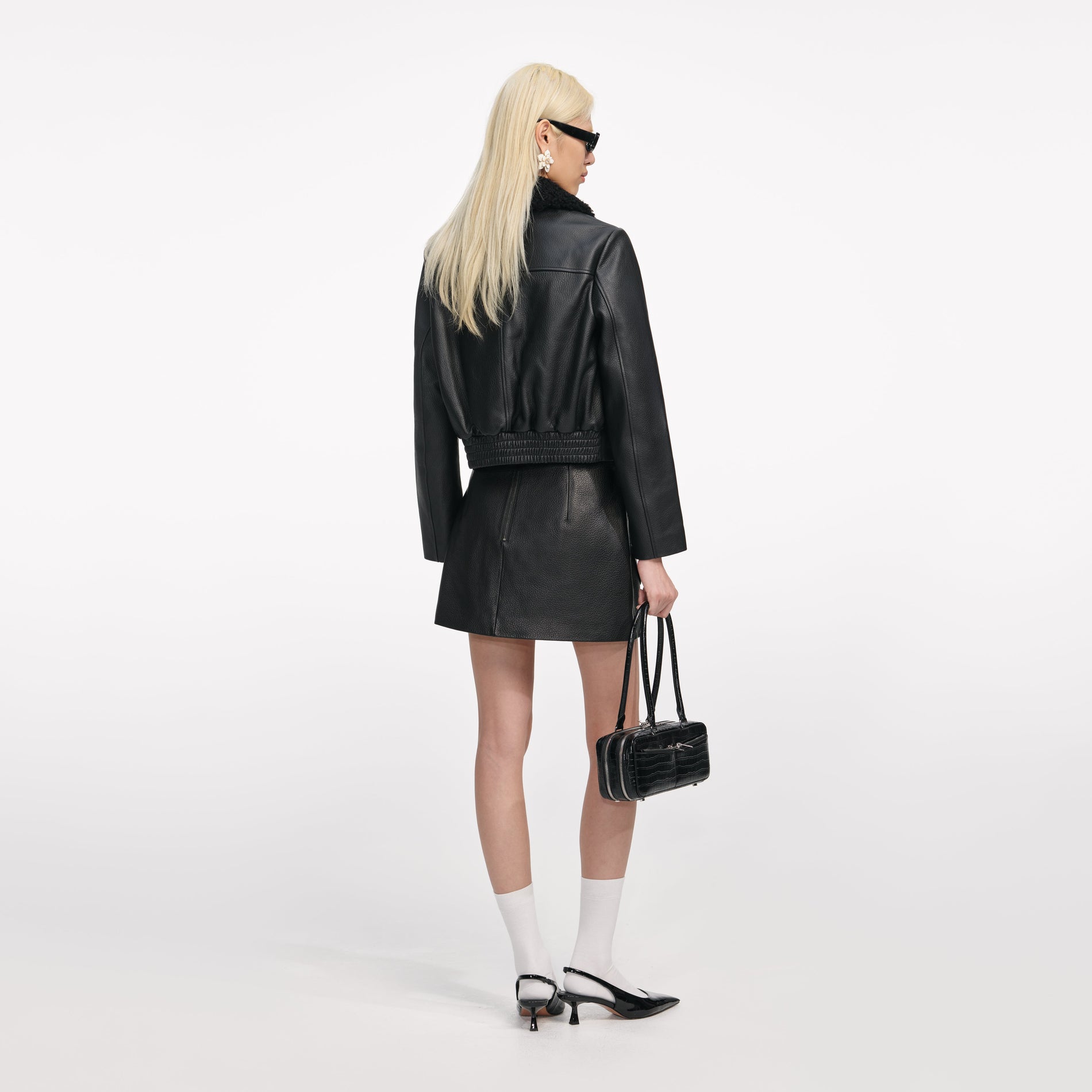 Back view of a woman wearing the Black Cropped Leather Jacket