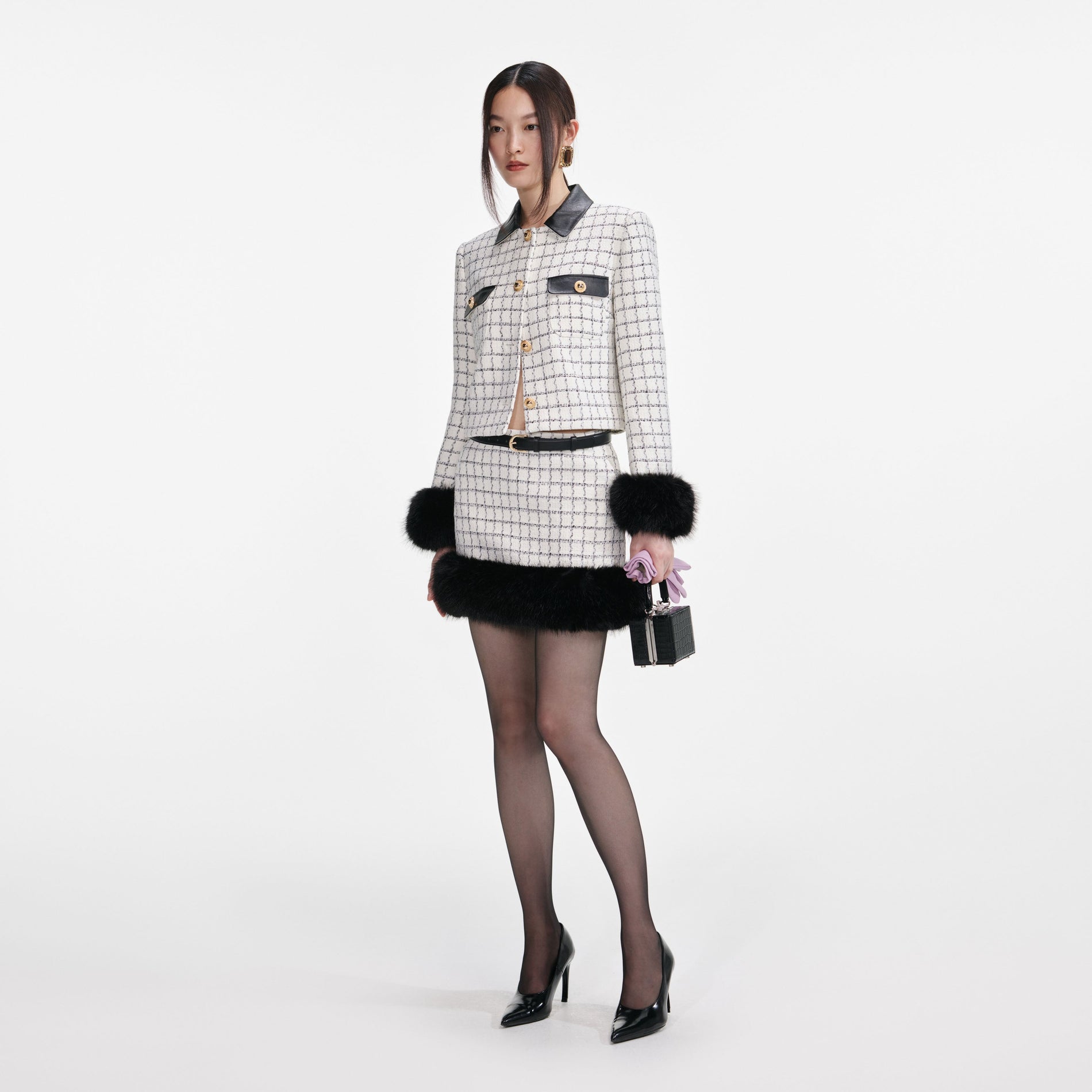 Side view of a woman wearing the Check Boucle Fur Cuff Jacket
