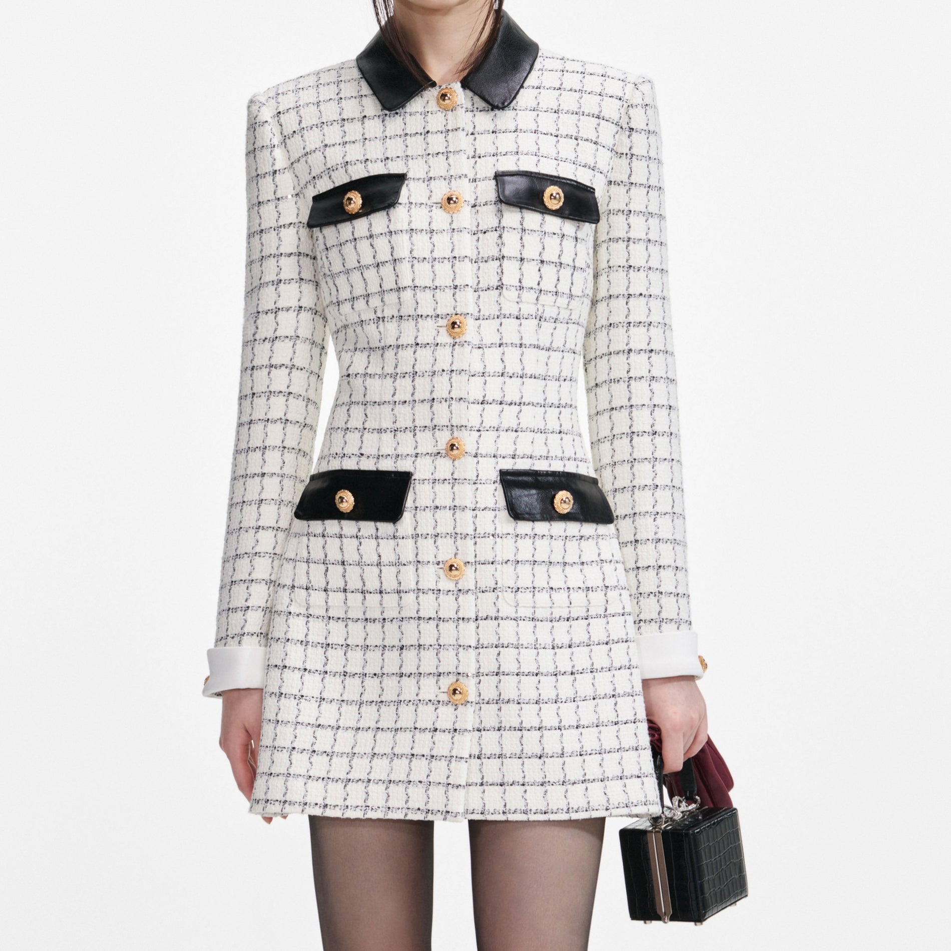 A close up of a woman wearing the Check Boucle Long Sleeve Mini Dress