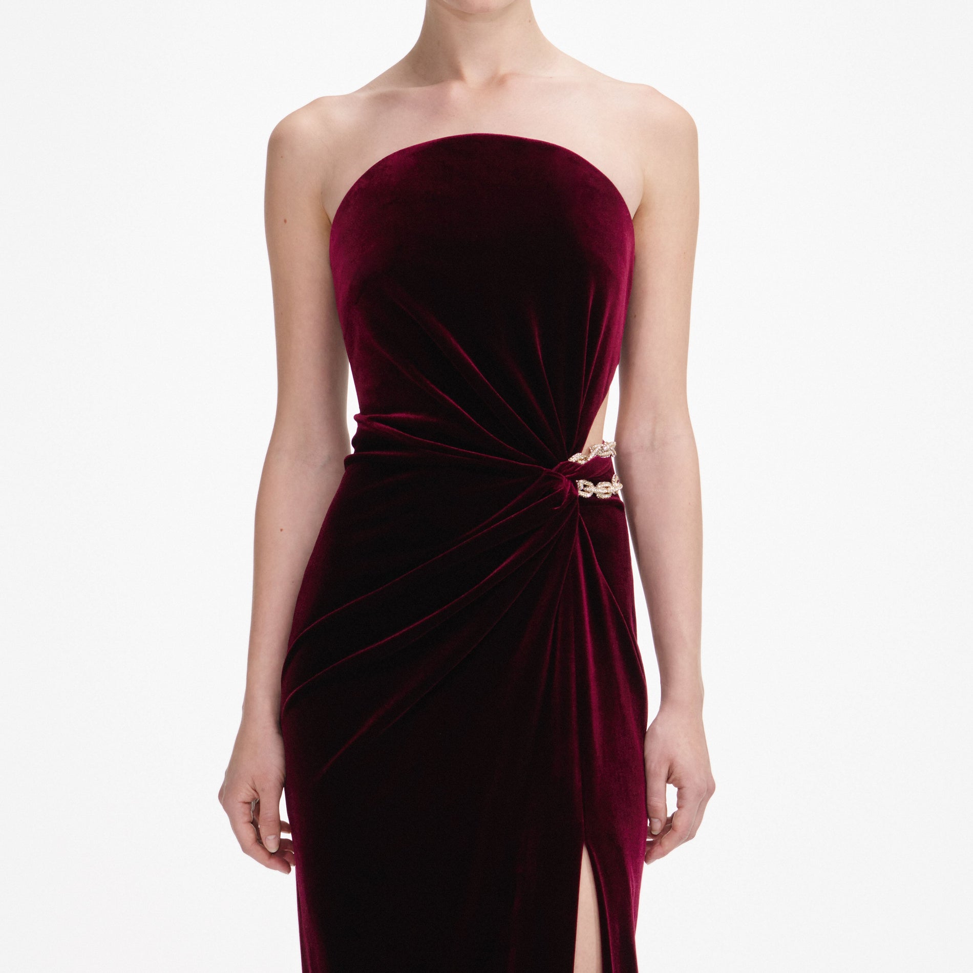 A close up of a woman wearing the Burgundy Velvet Bandeau Maxi Dress