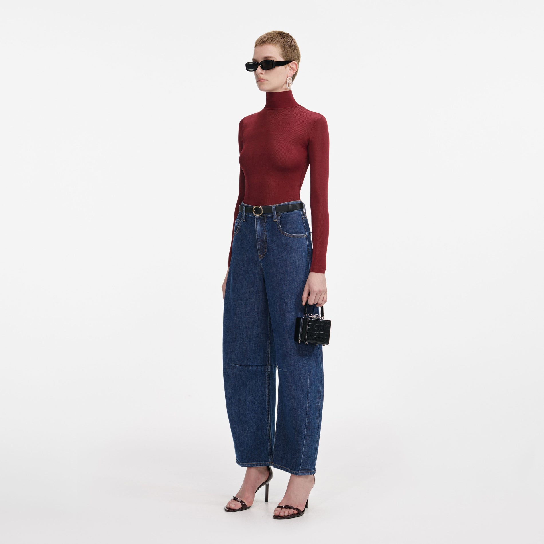 Side view of a woman wearing the Burgundy Viscose Knit Top