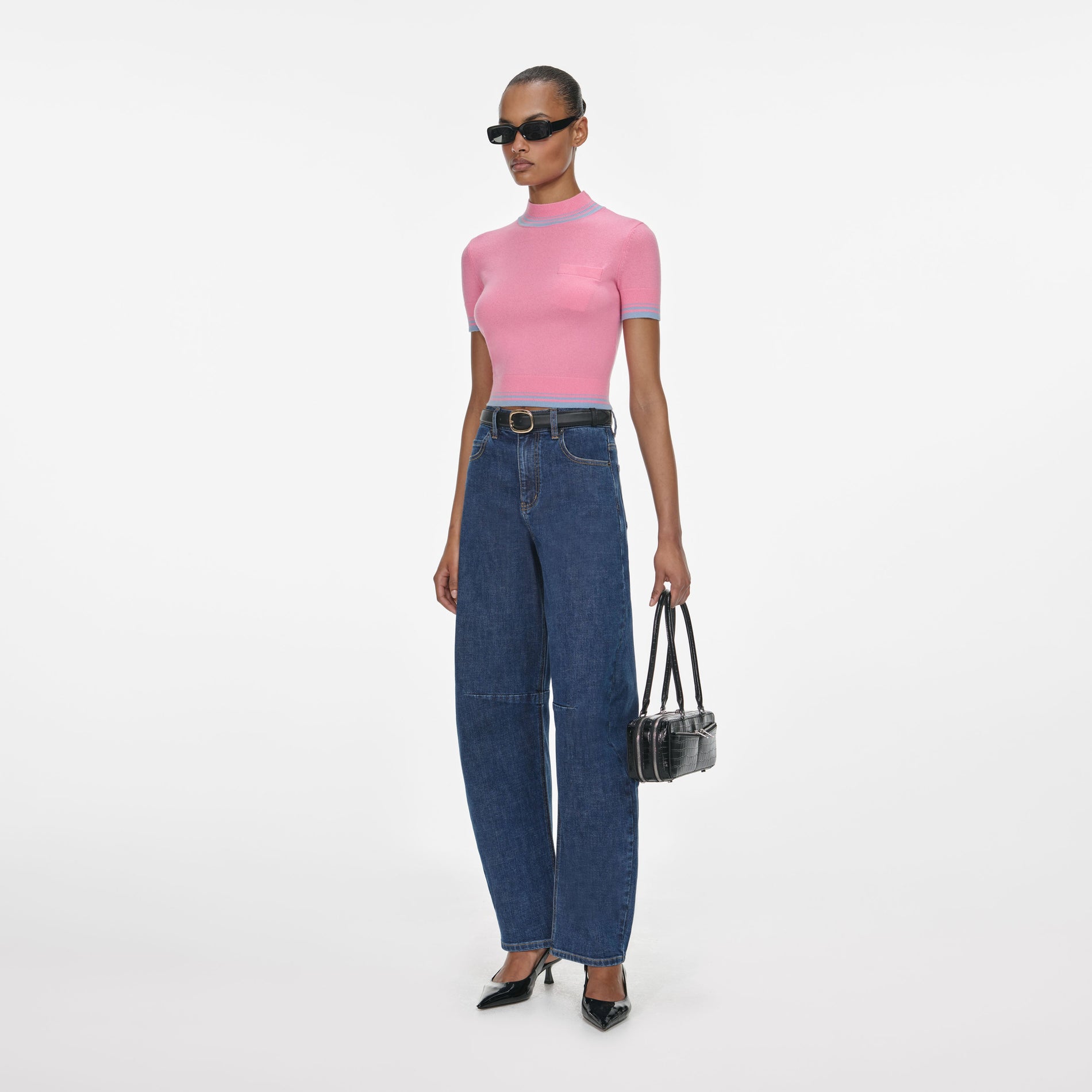 Side view of a woman wearing the Pink Contrast Stripe Knit Top