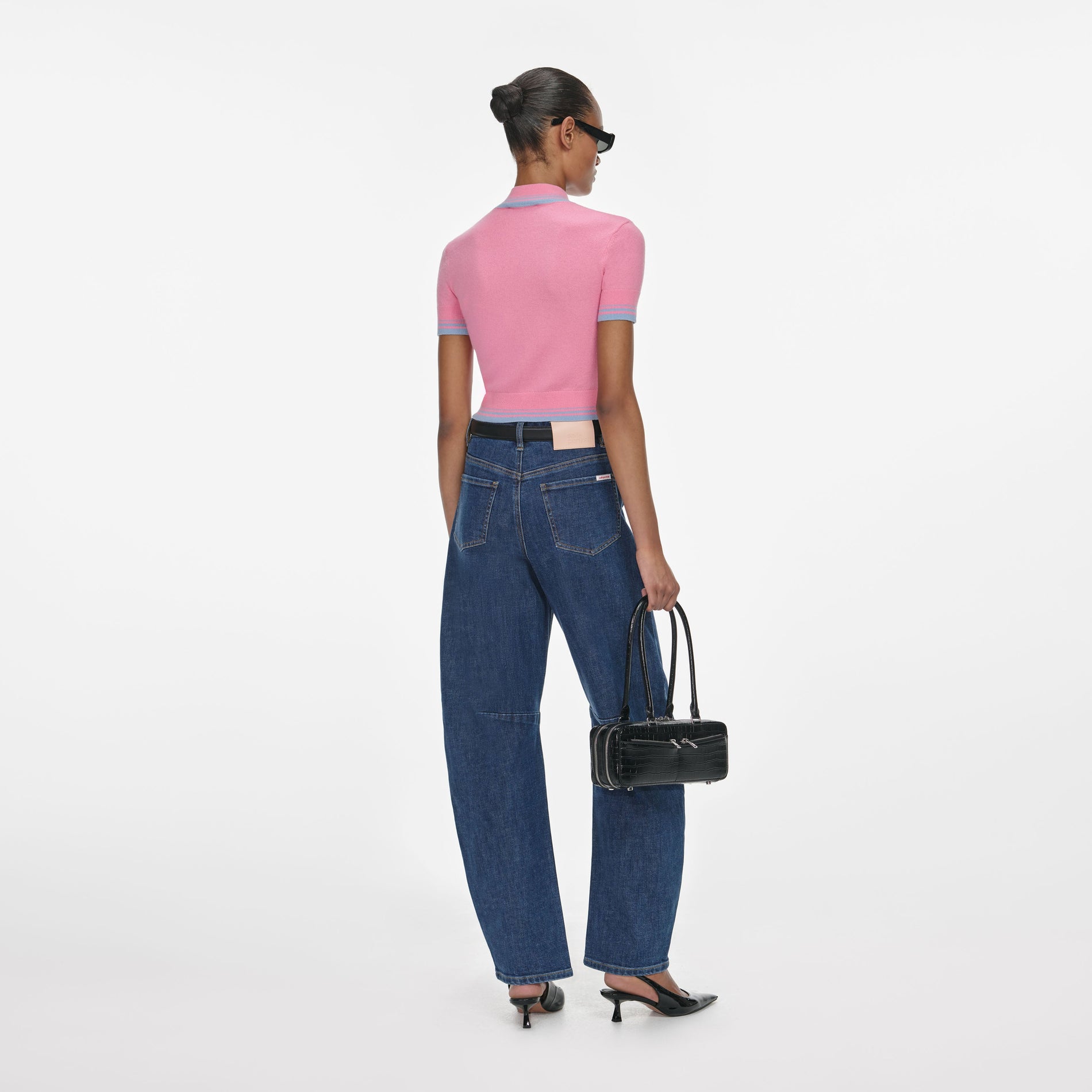 Back view of a woman wearing the Pink Contrast Stripe Knit Top