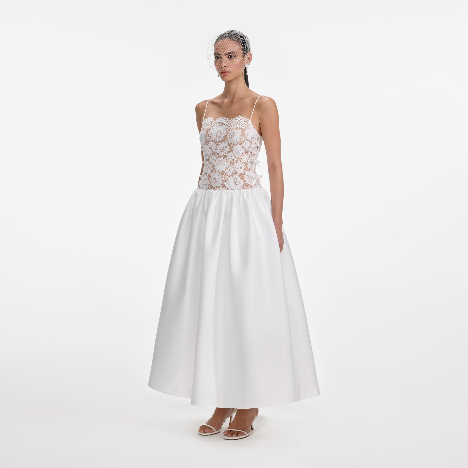 Side view of a woman wearing the White Lace Taffeta Maxi Dress